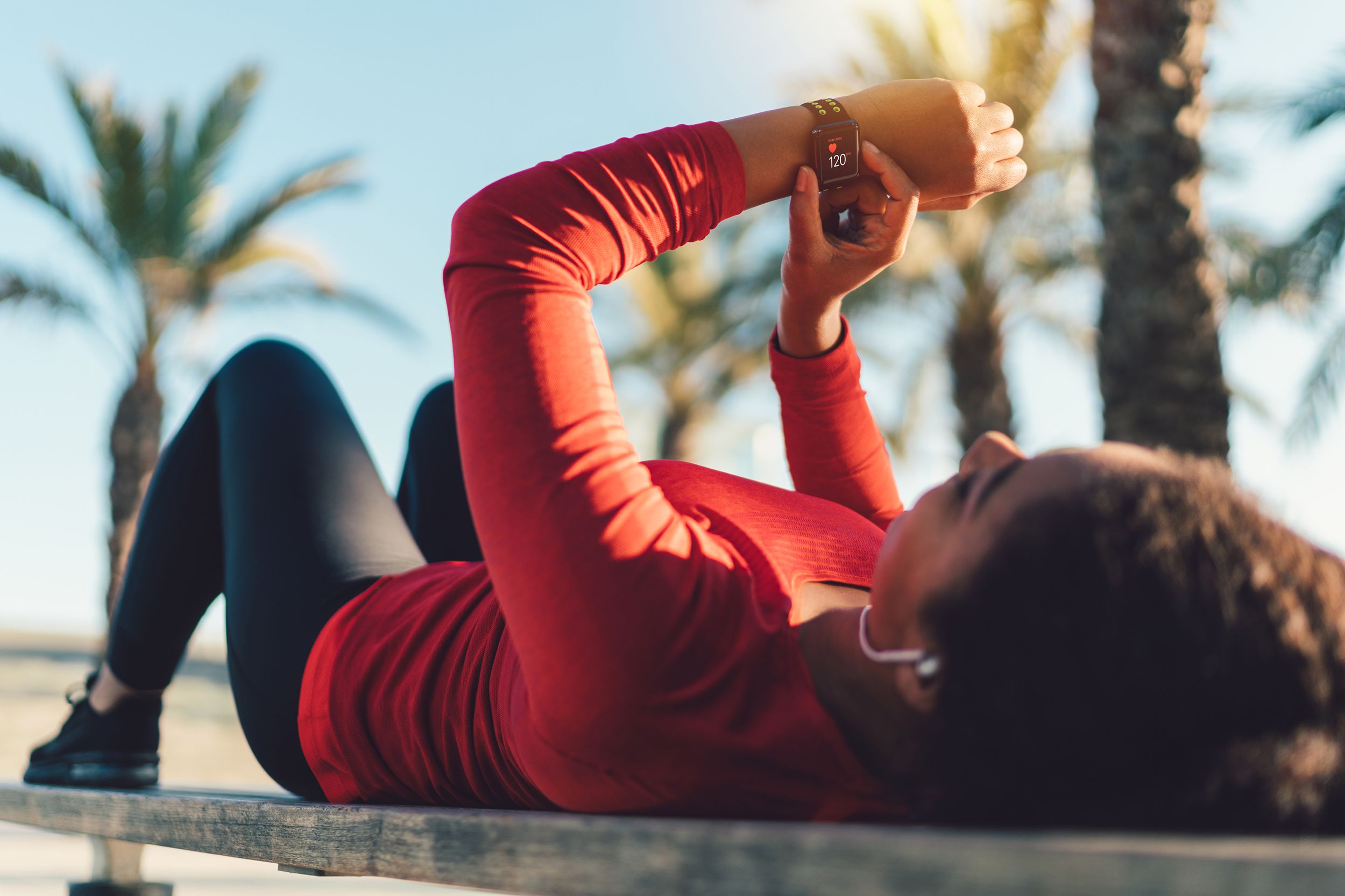 sportswoman checking pulse on smartwatch