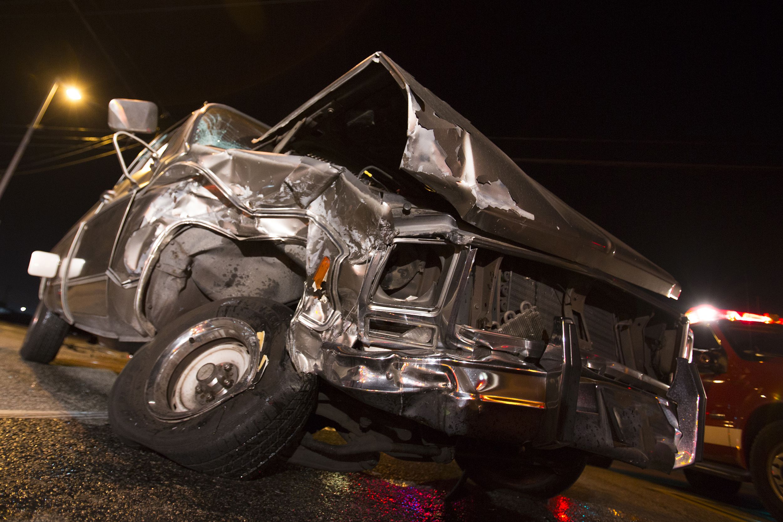 smashed truck in auto accident at night