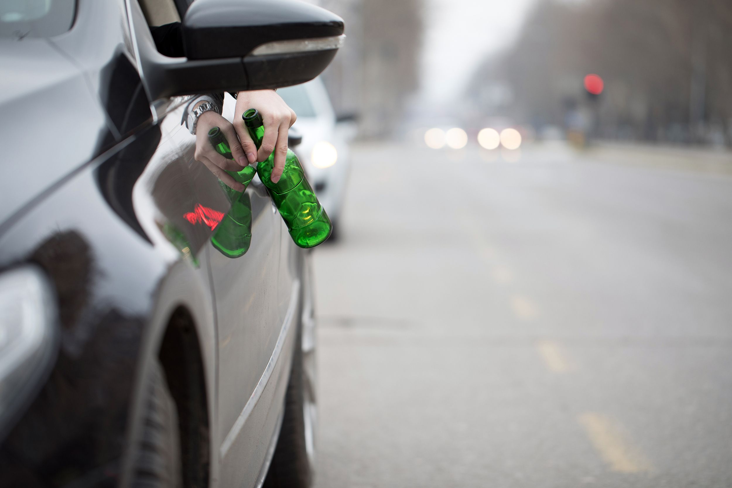 driver in the car drinks beer