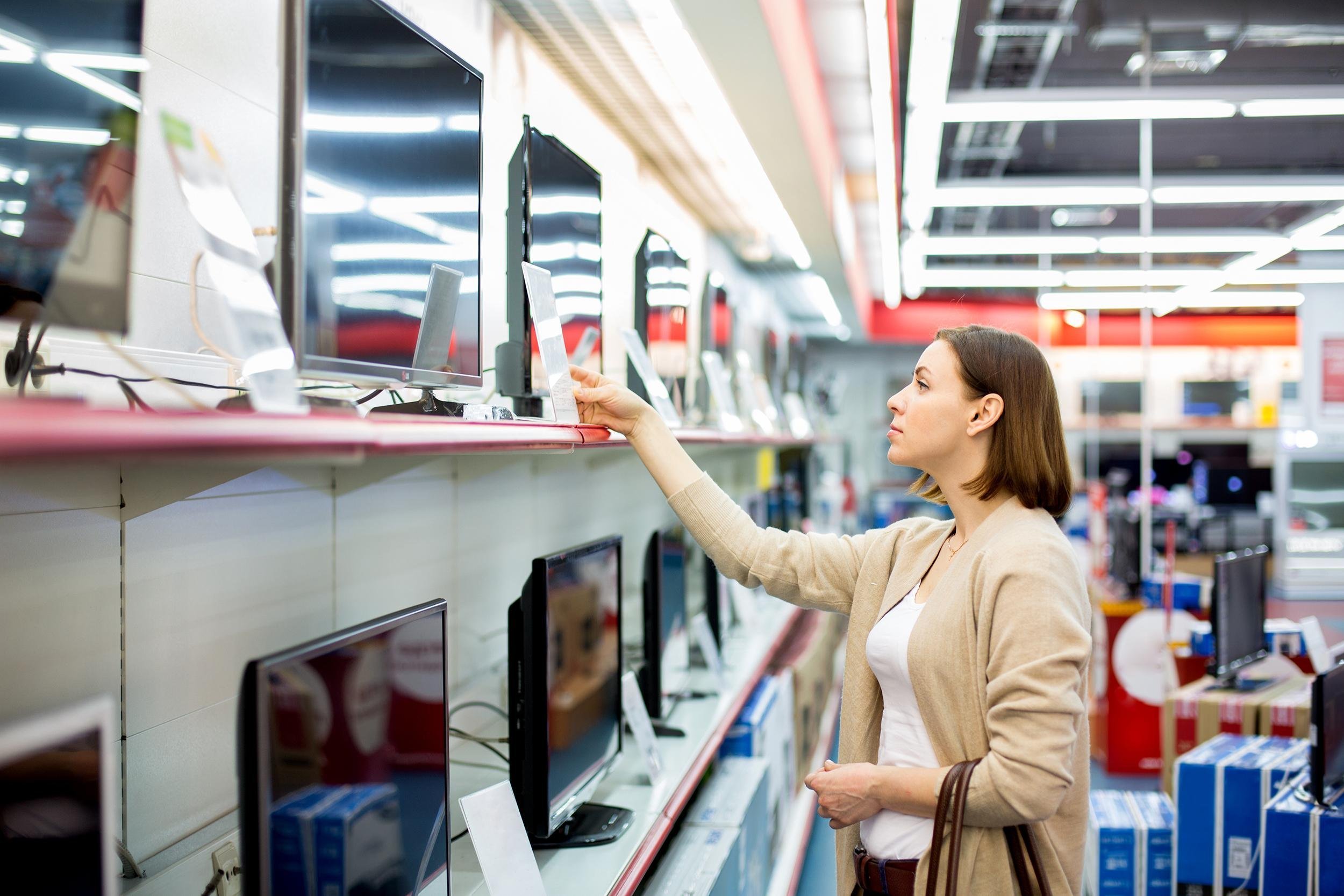 woman shopping for a TV in the store