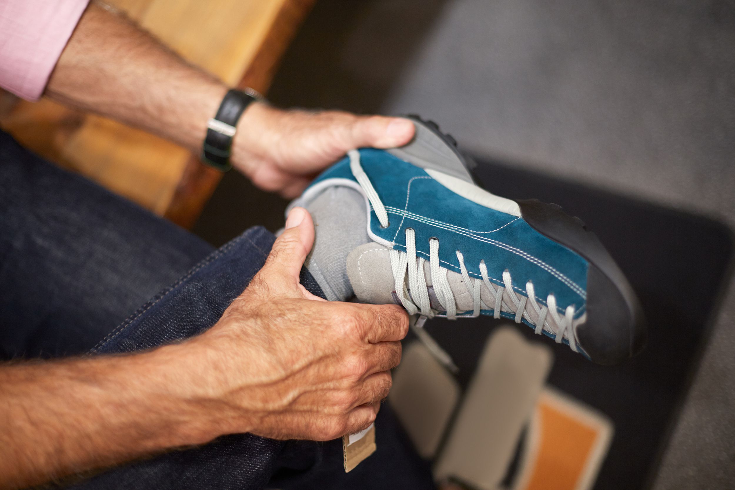 man shopping for new shoes in store
