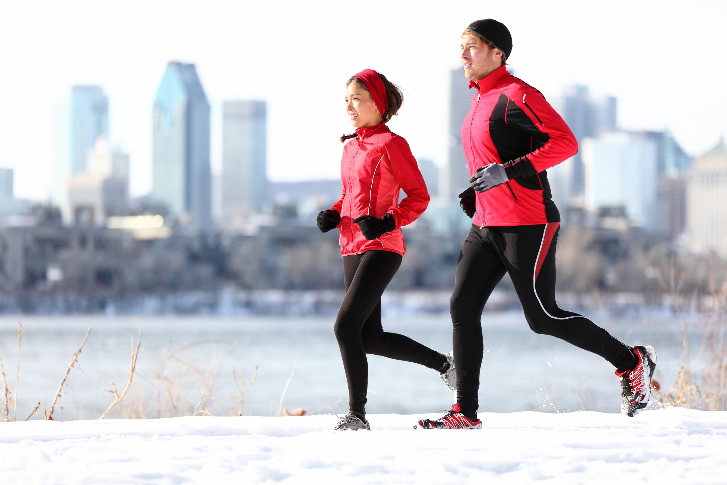 two people jogging in city at winter