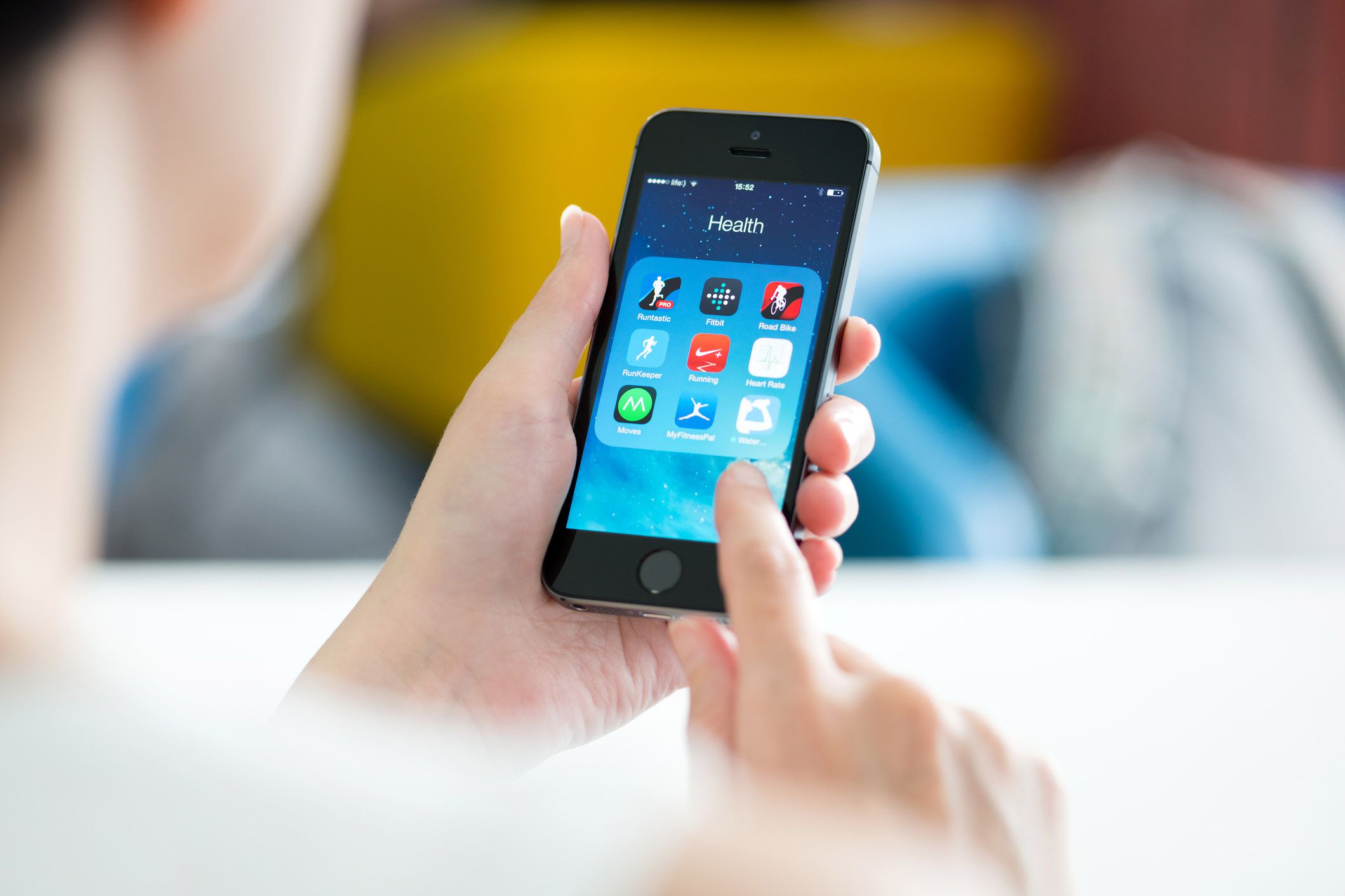 hand holding phone with health apps open