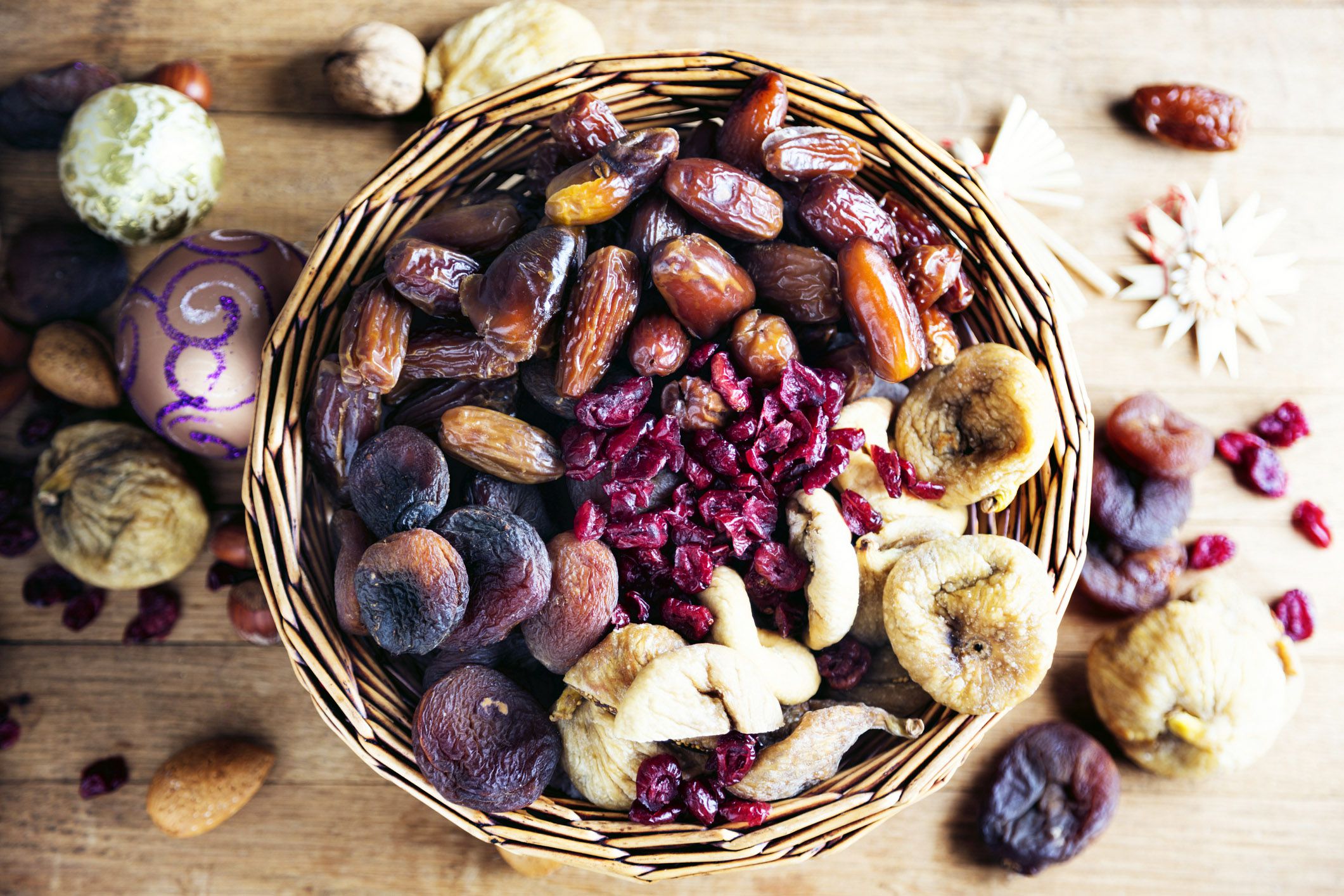 basket of dried fruits and nuts with christmas ornament