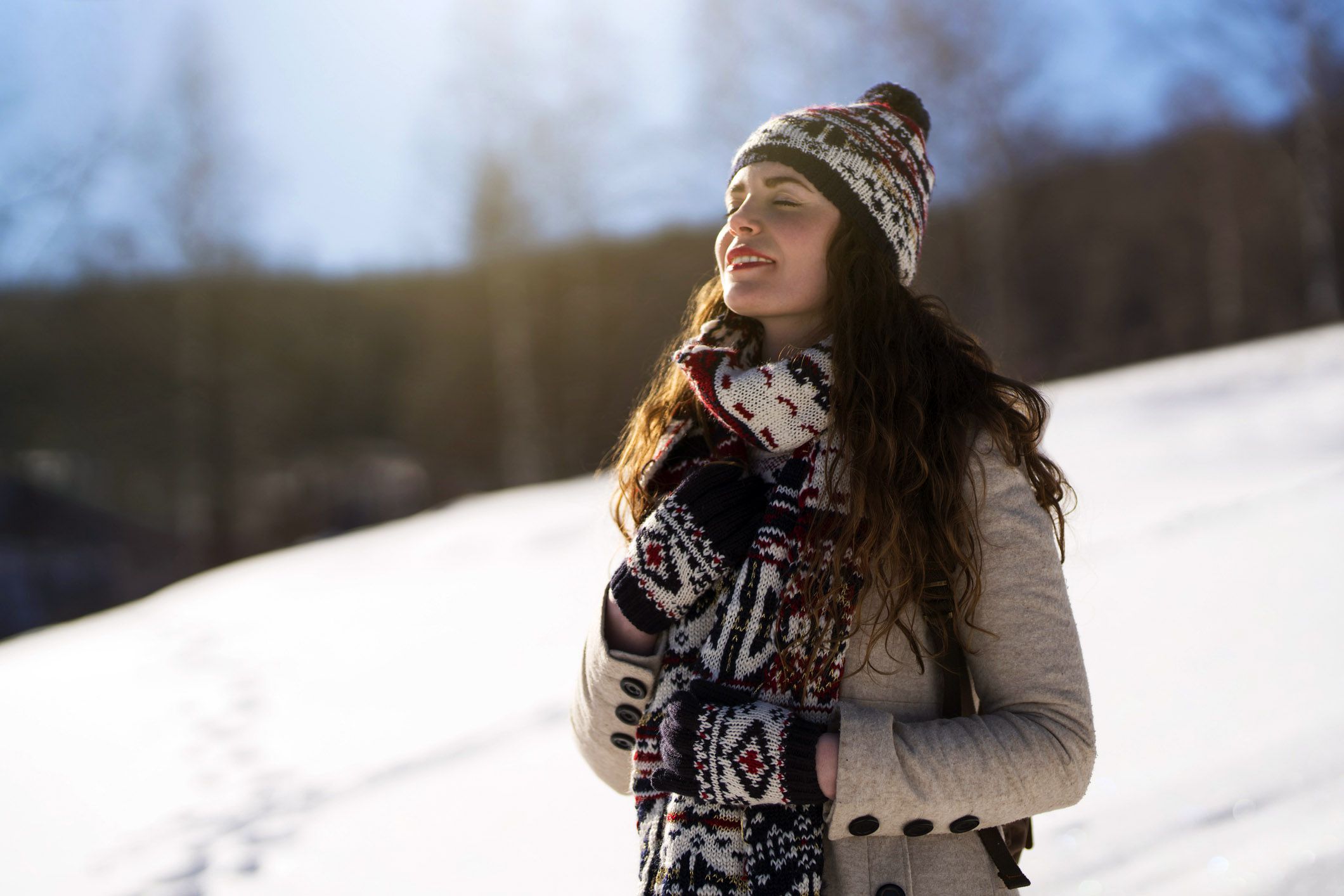 young person taking breath of fresh air smiling outdoors in wooden garments