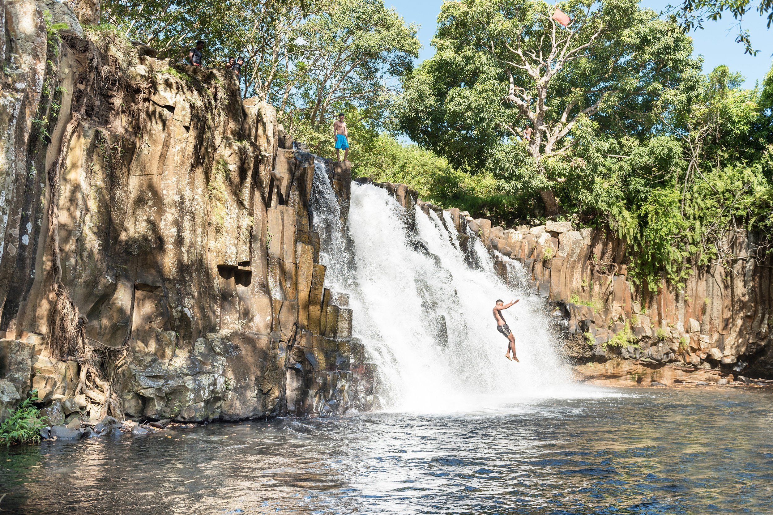 man cascading in a waterfall
