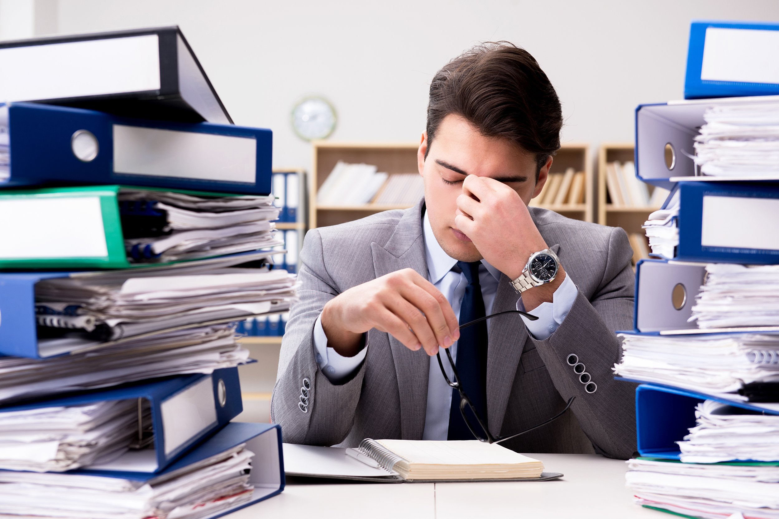 busy businessman under stress due to excessive work