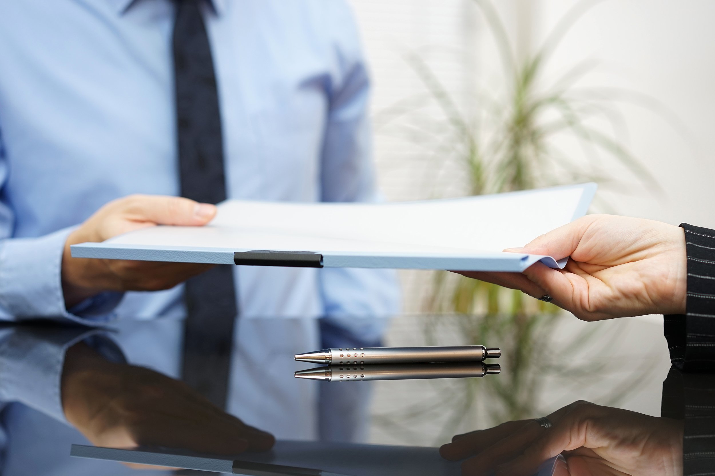 businessman is passing signed agreement to client