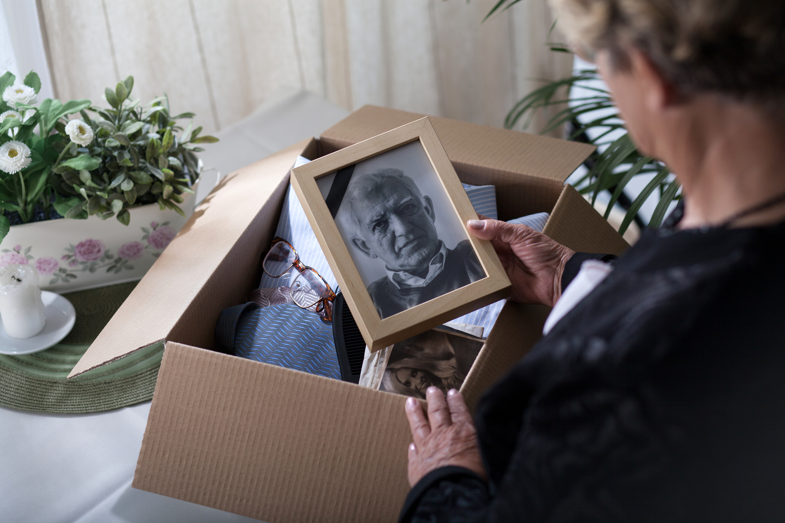 Widow looking at a photo of her late husband