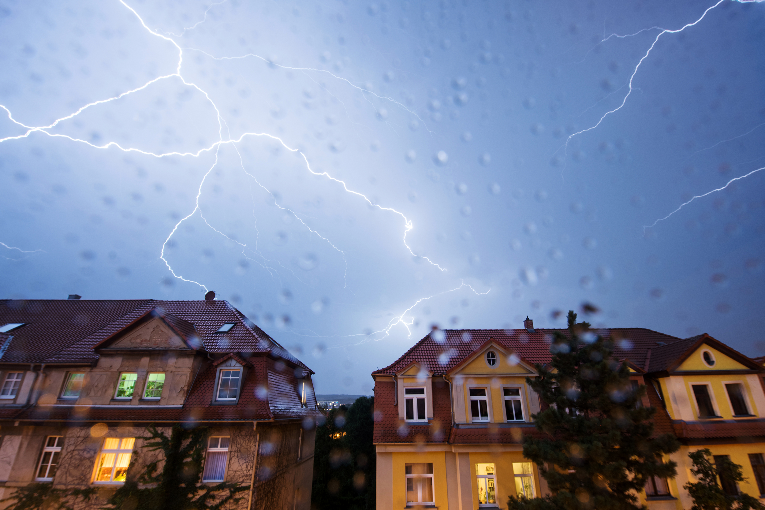 Lightning strikes over houses