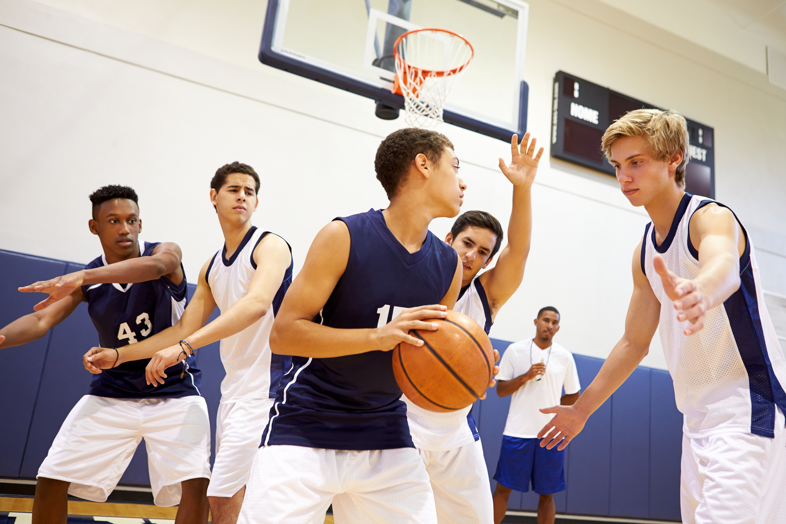High school teenagers playing basketball