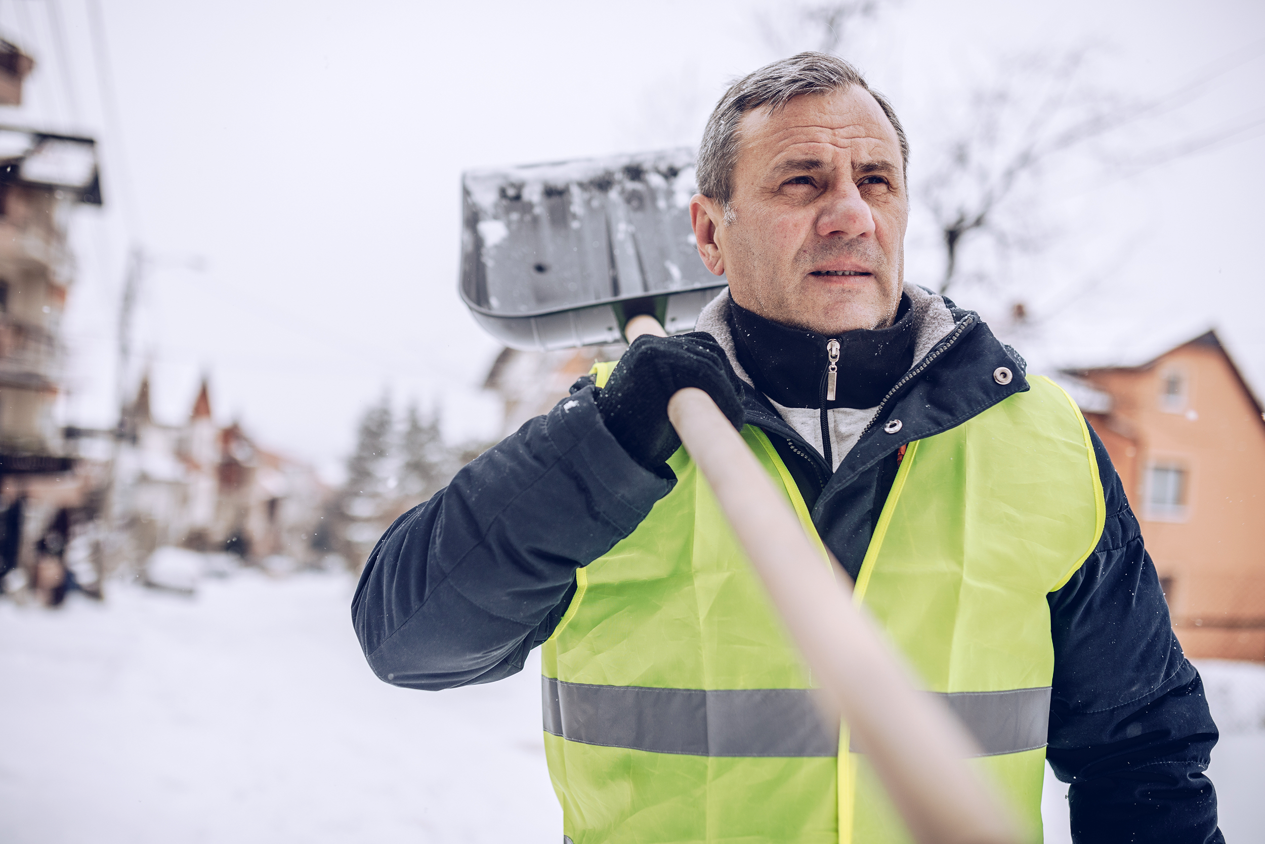 Man shoveling snow in the neighborhood