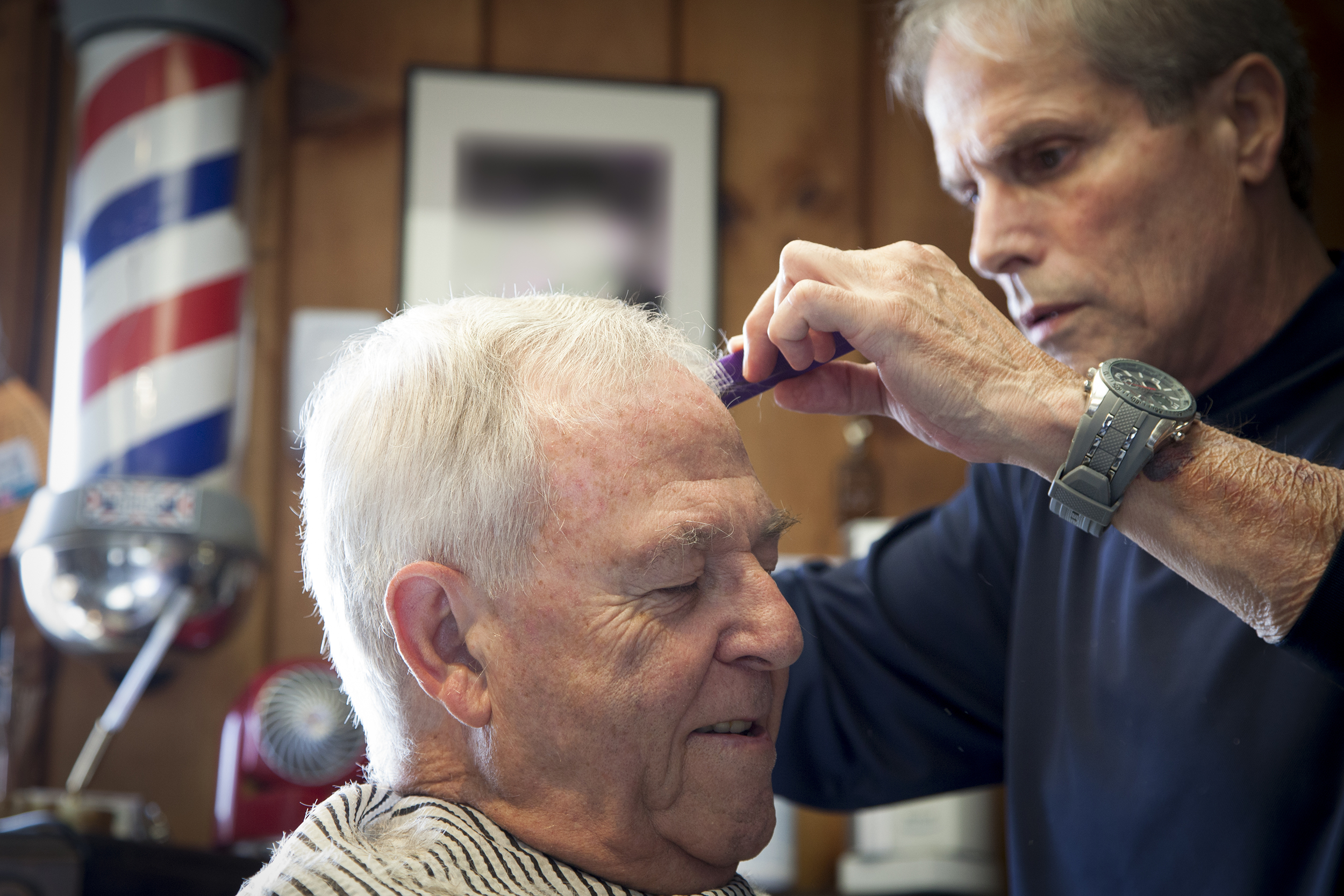 Older man getting a haircut at the barber shop