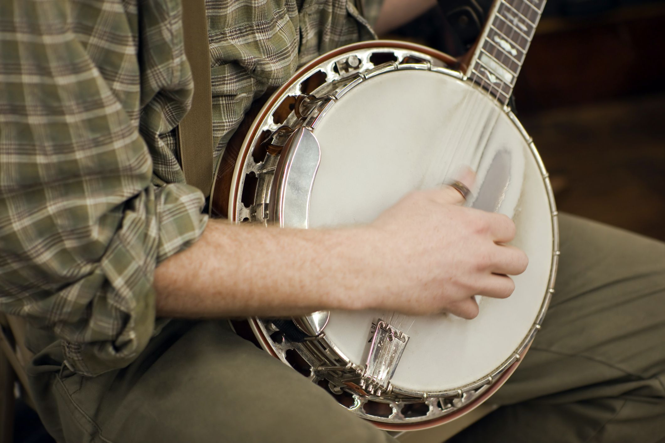 close-up of hands playing banjo