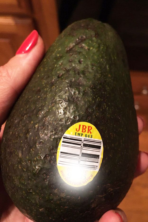 brought avocado from Kroger with hand holding at home