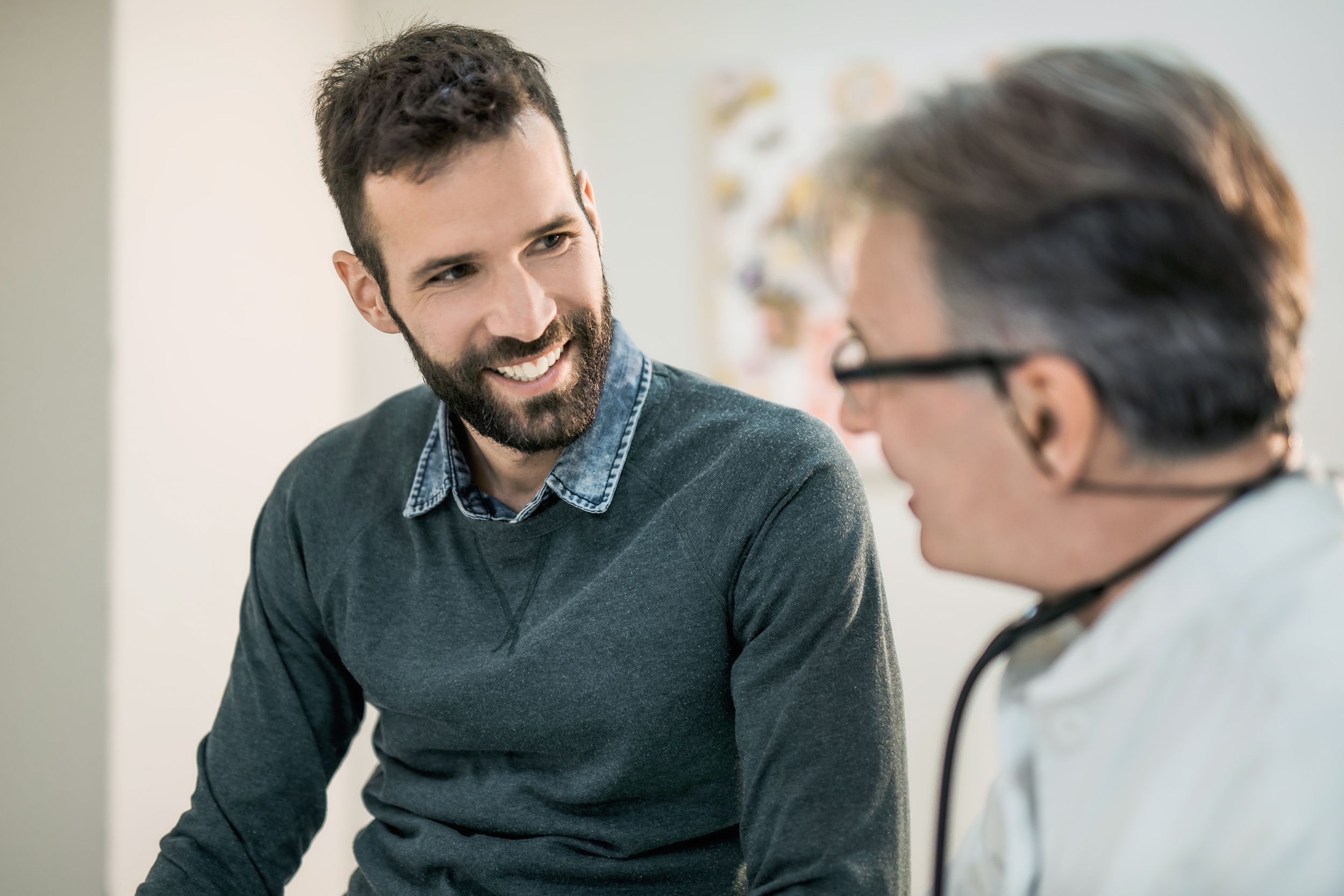 happy male patient talking with his doctor