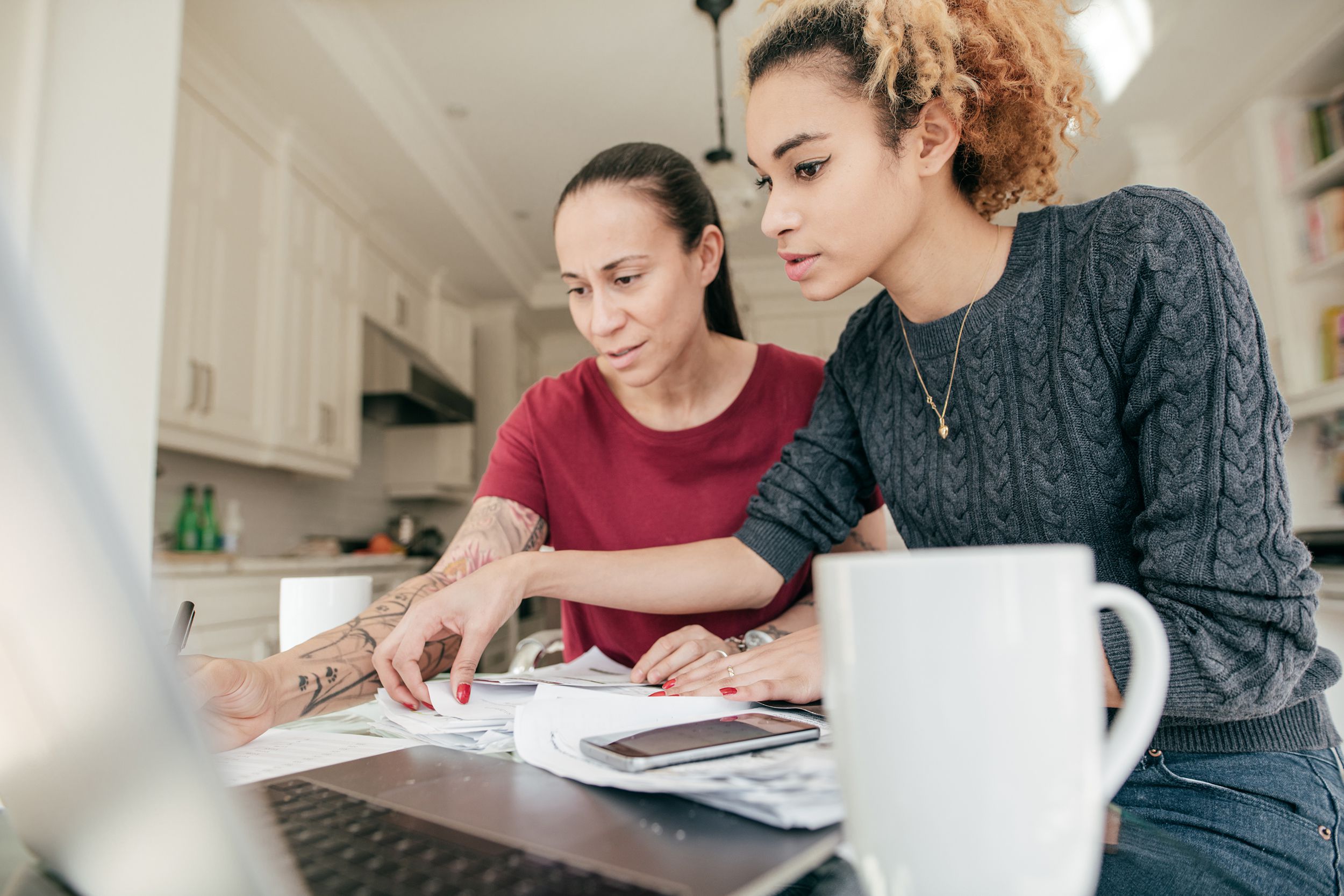 couple doing finances at home with laptop