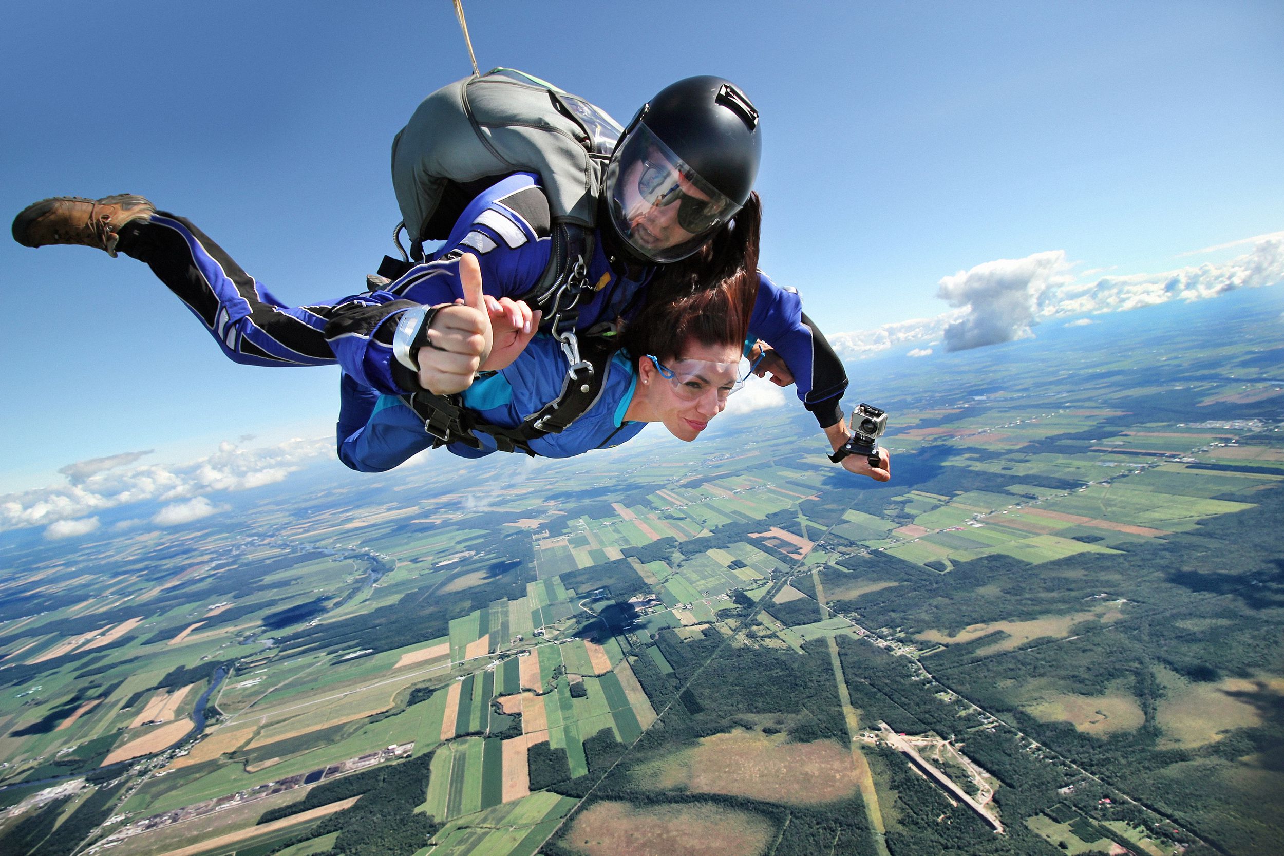 two people sky diving with one giving thumbs up