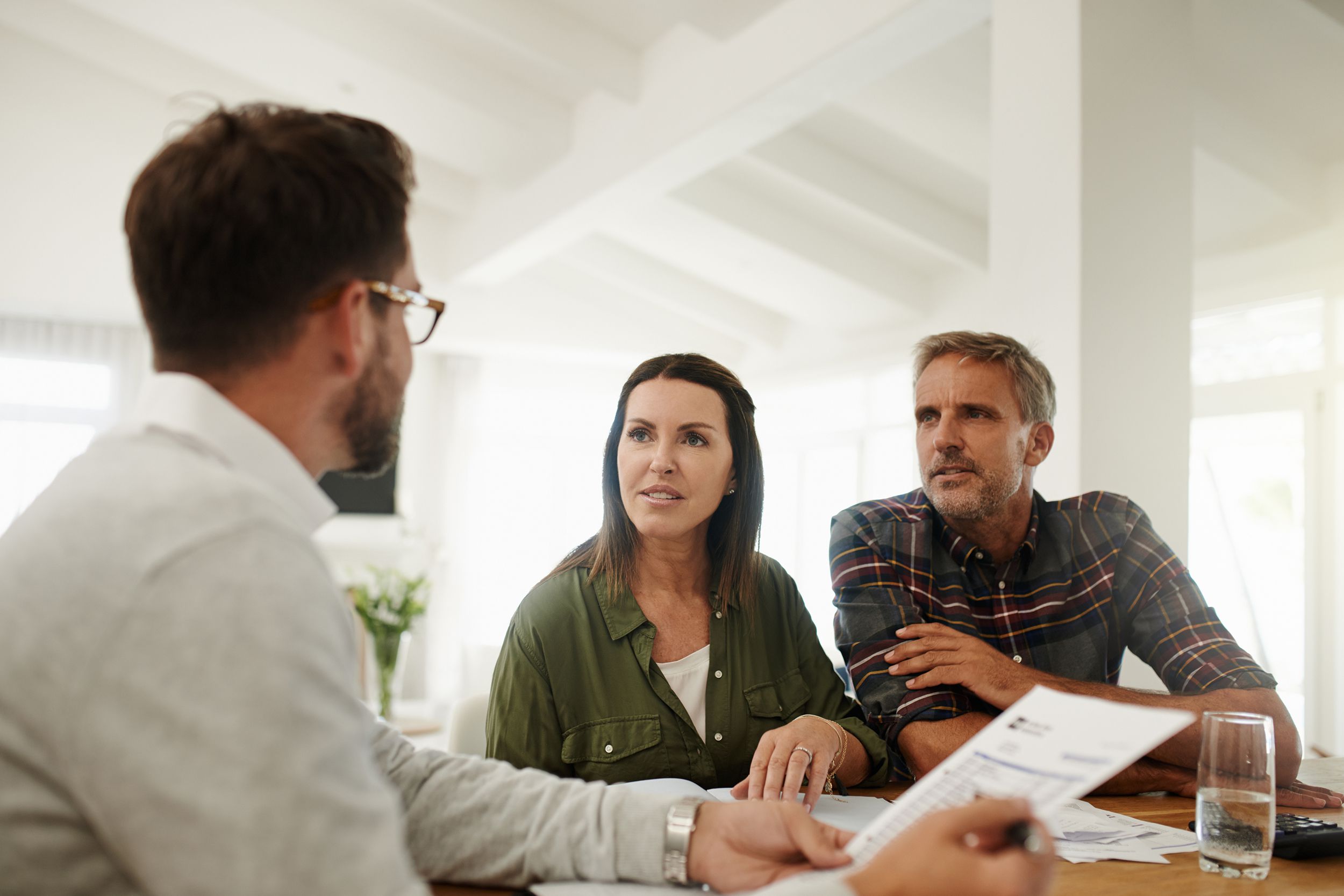 couple going over life insurance at home with agent