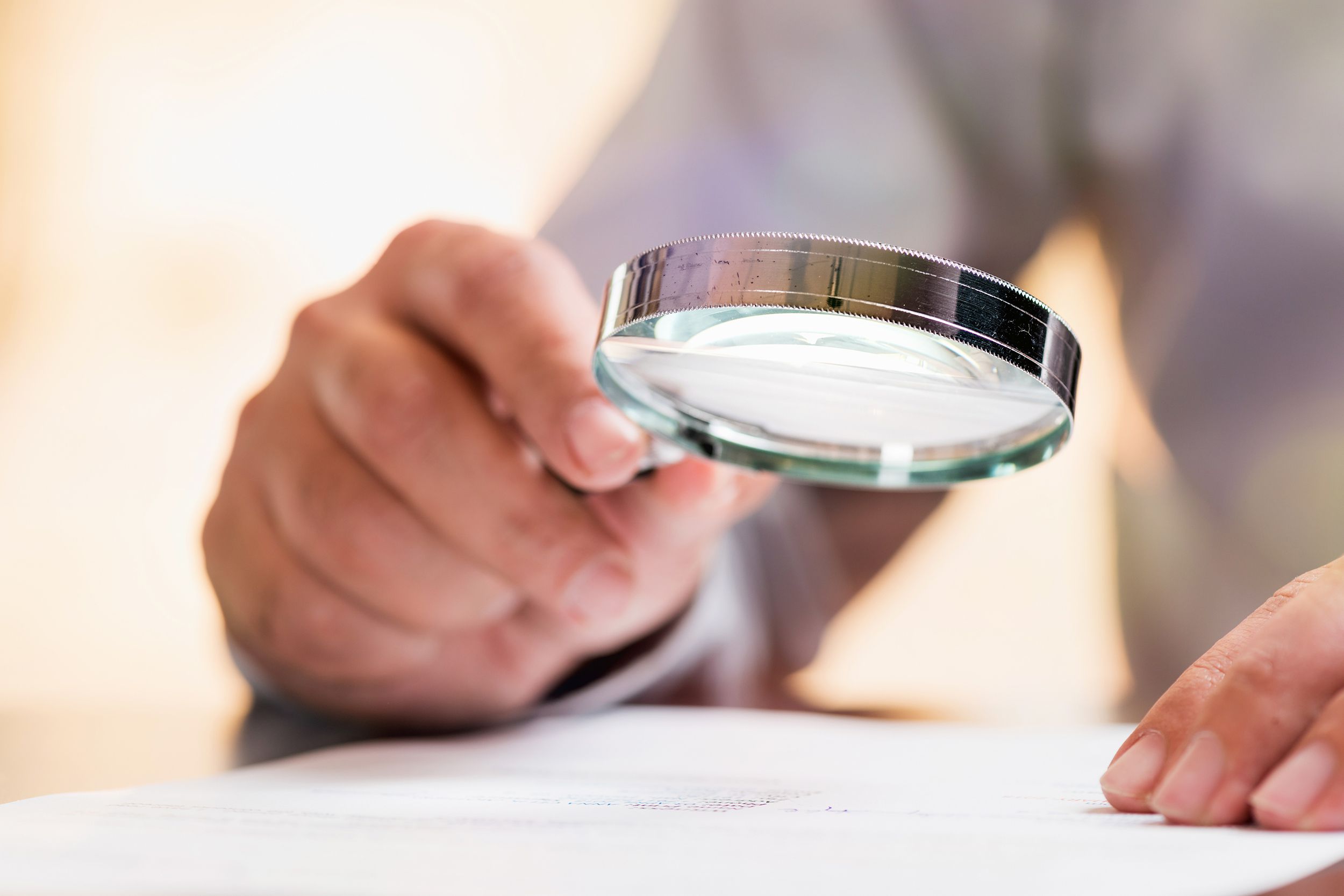 businessman reading contract details before signing