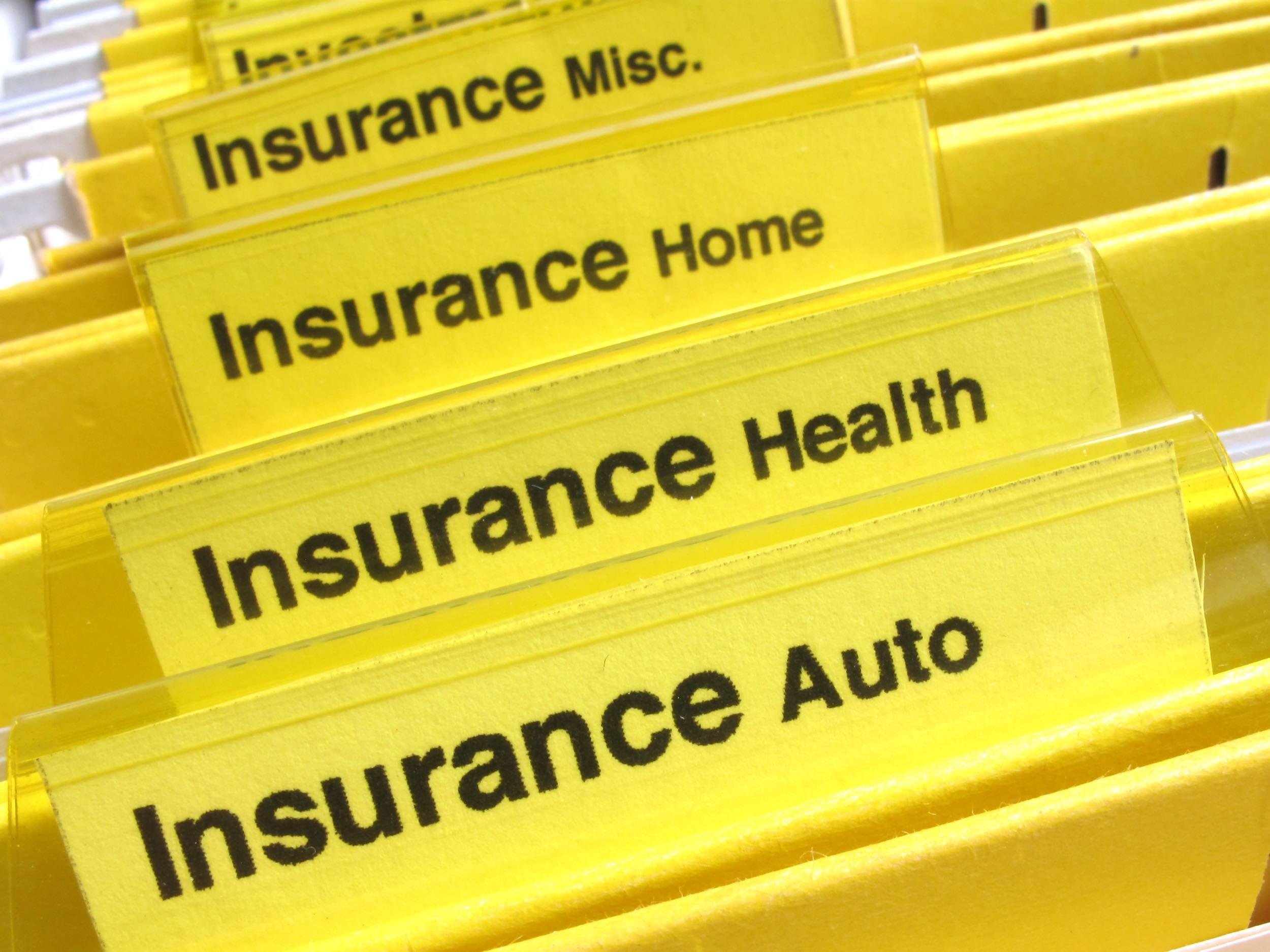 yellow folders show different types of insurance papers