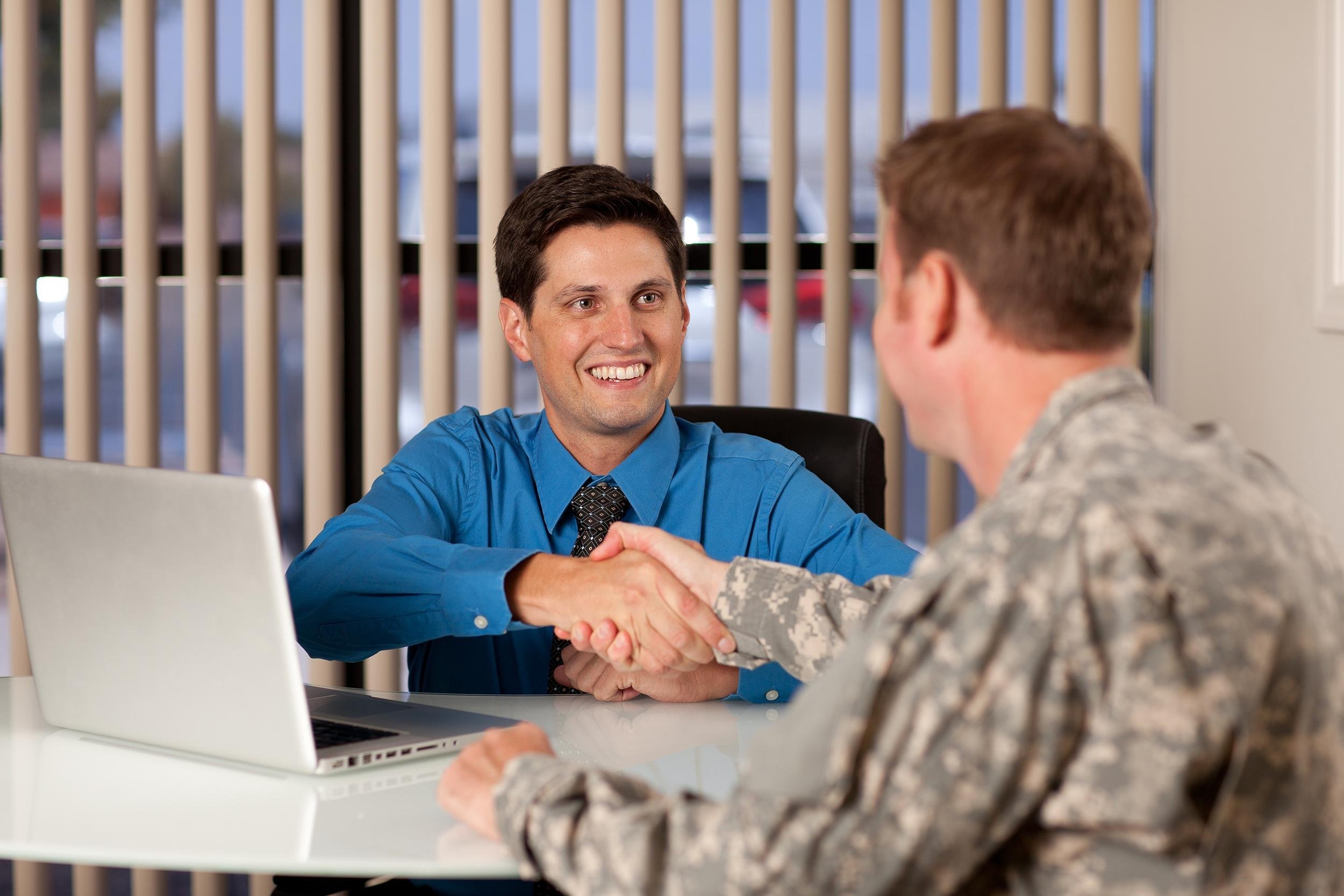 businessman and soldier shaking hands