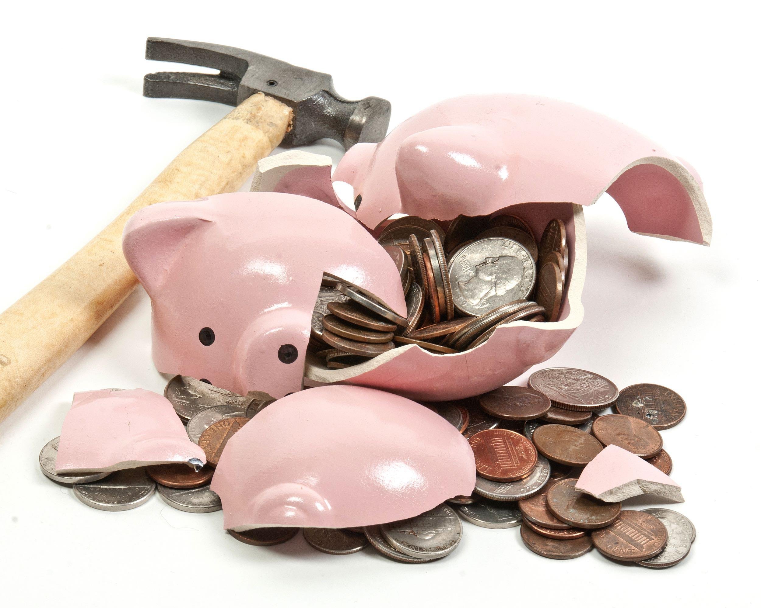 broken piggy bank filled with loose change