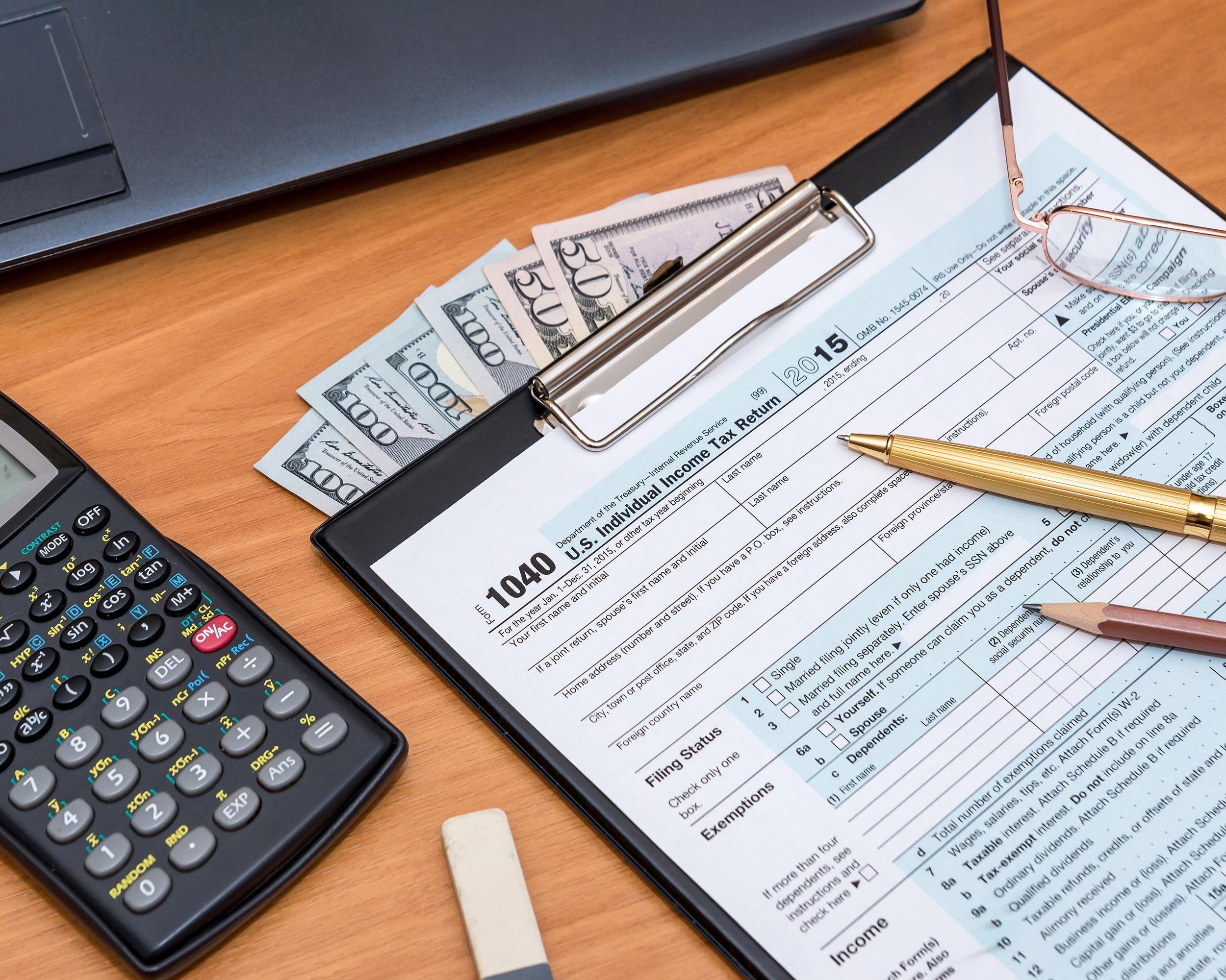 tax form with computer on table