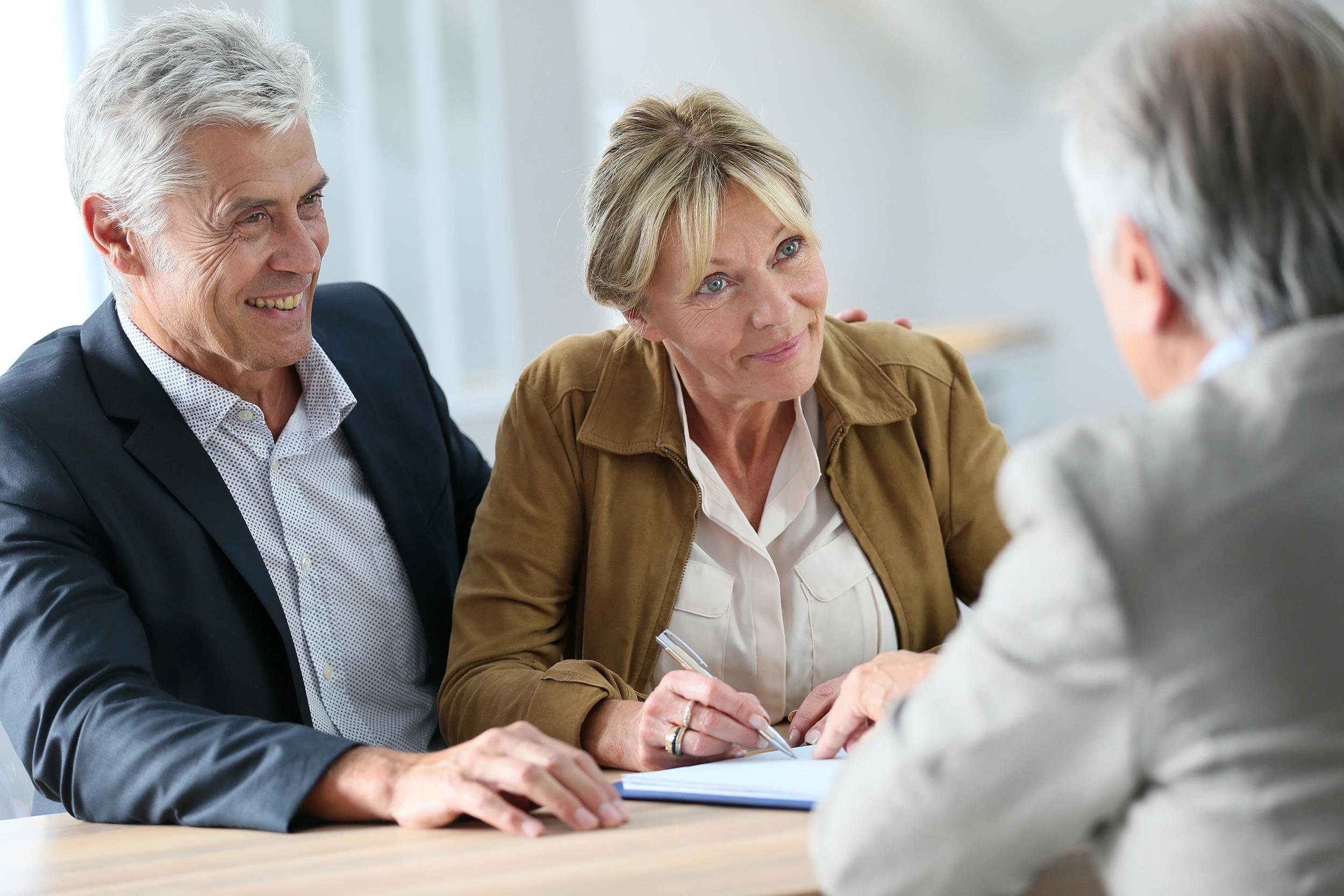 senior couple meeting real-estate agent