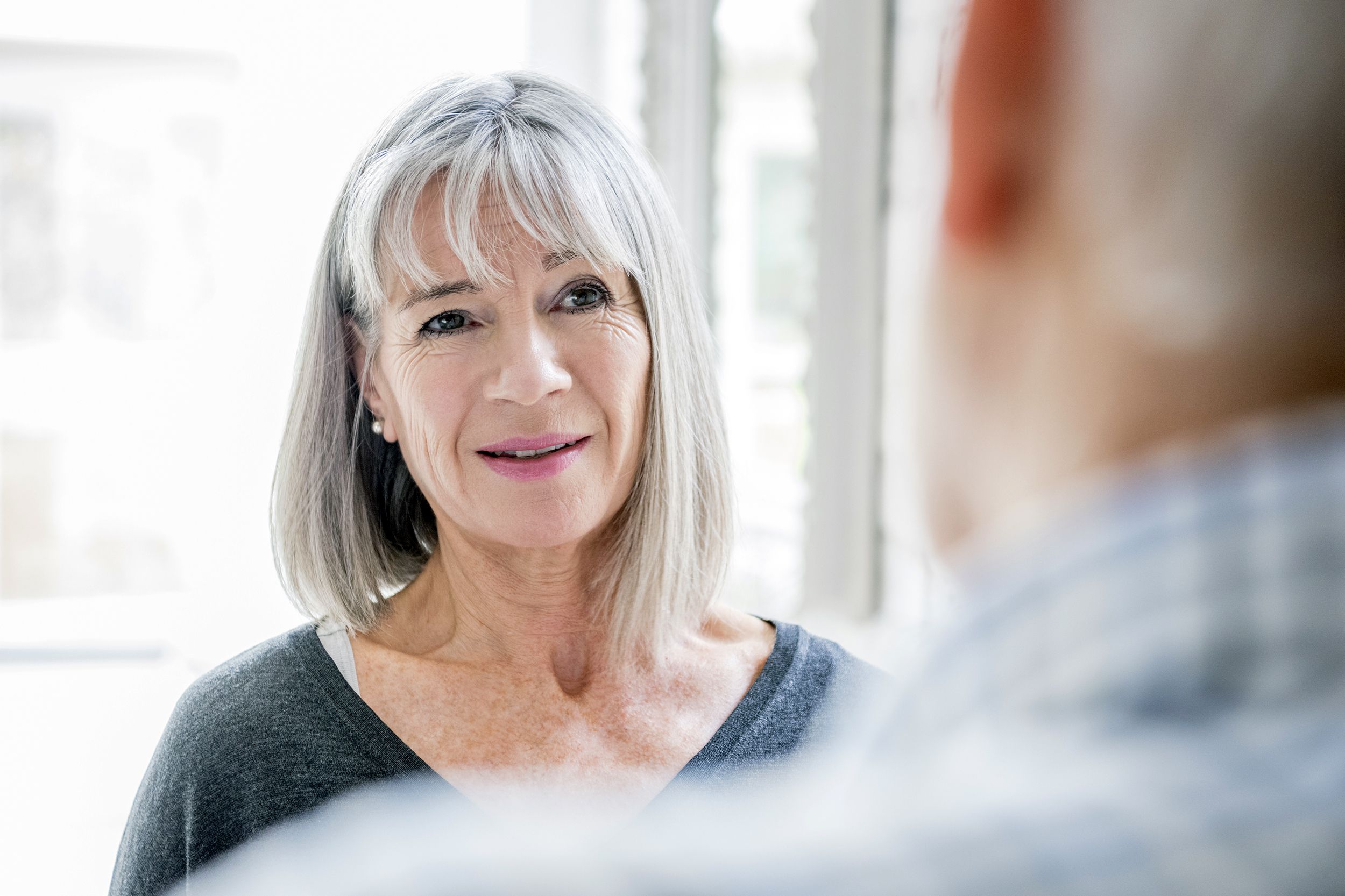 Senior woman listening to a man talk