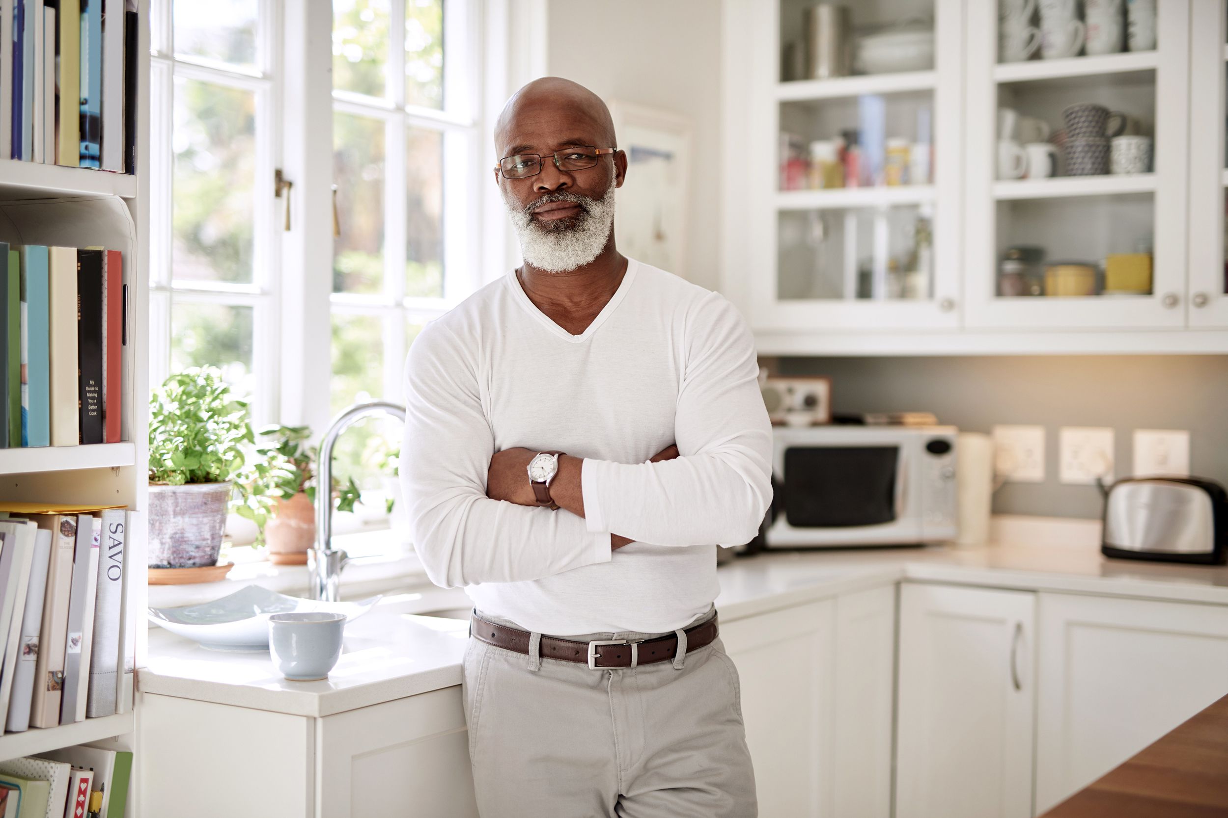 Senior man standing with arms folded