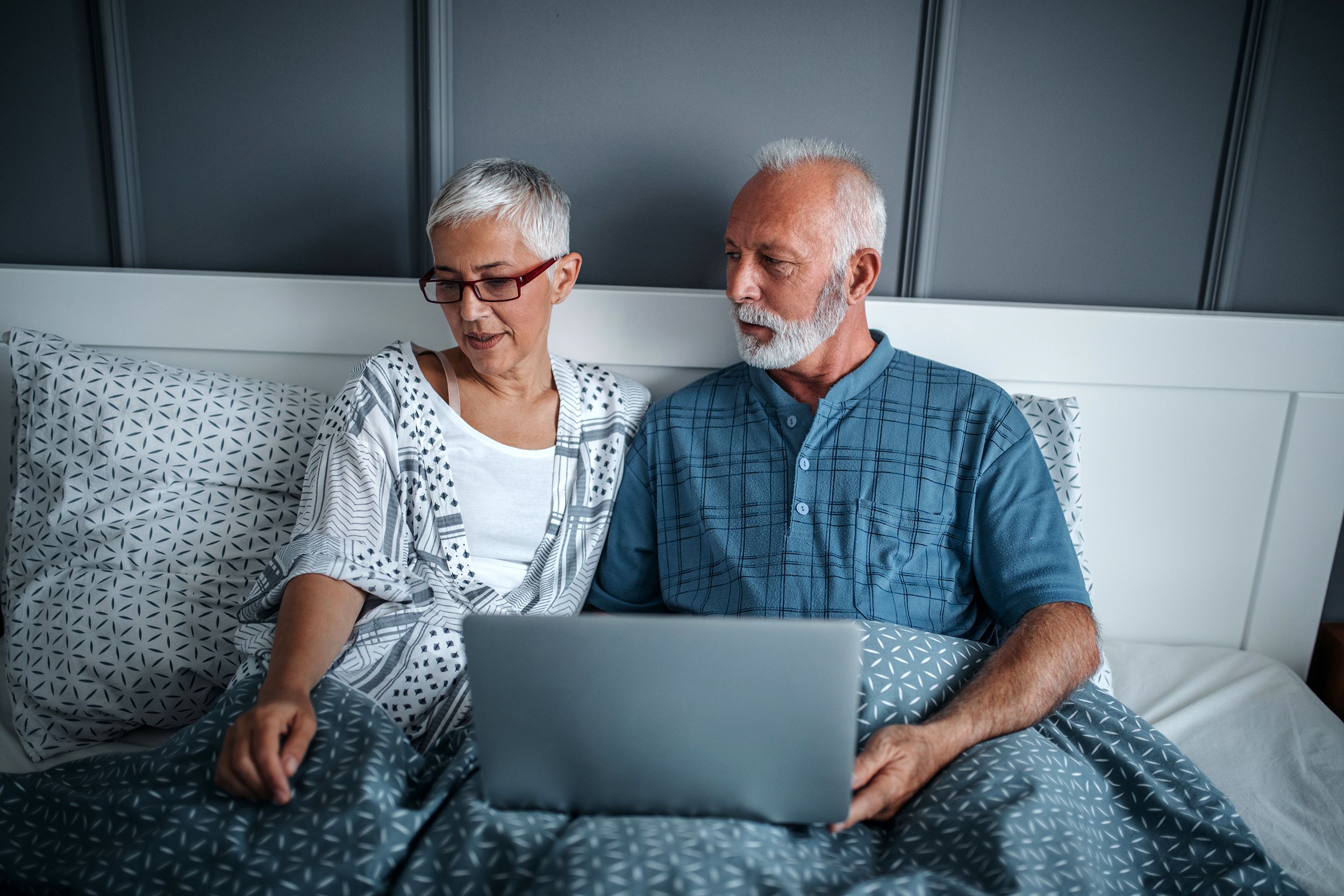 Senior couple having a serious talk in bed