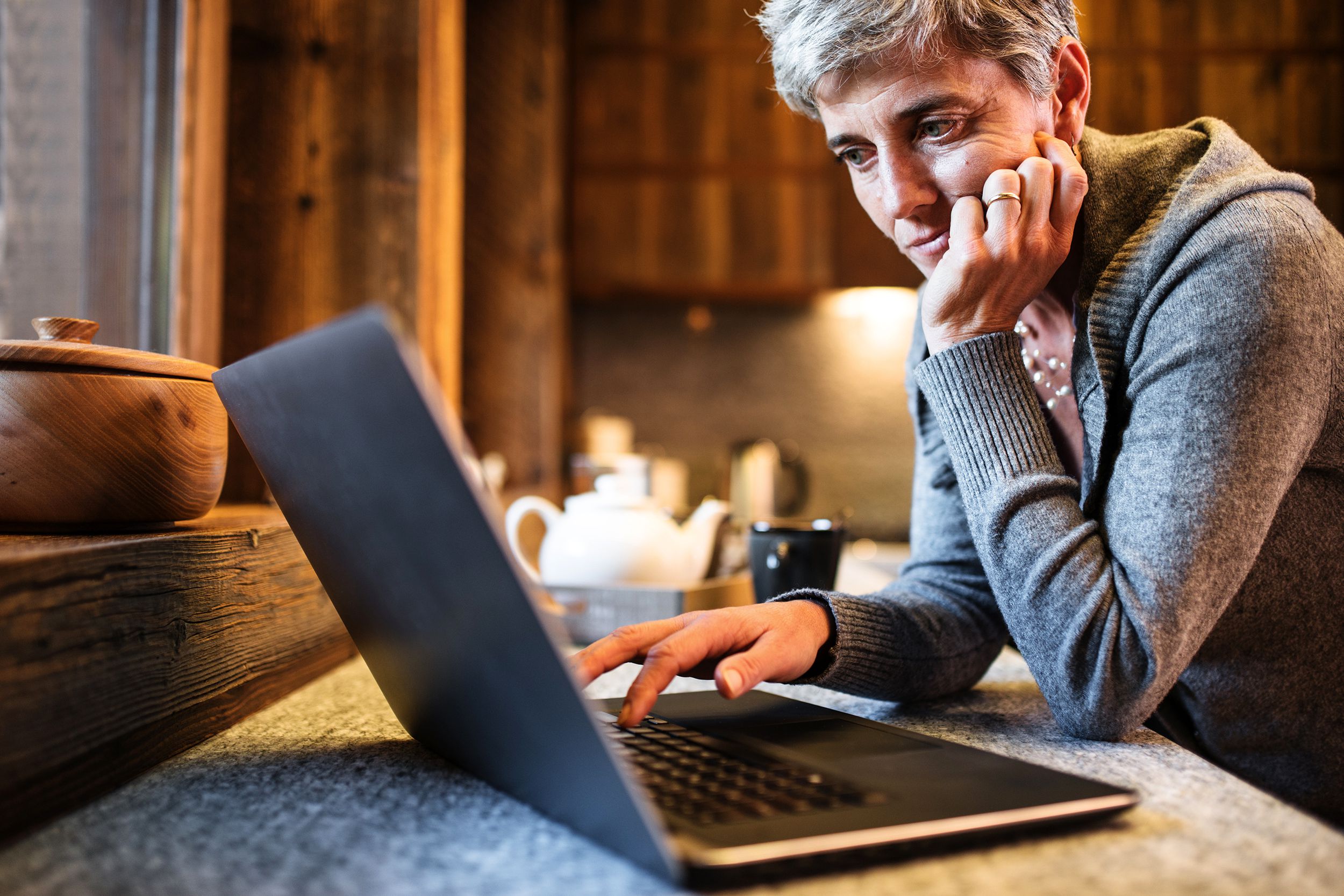 Sad looking woman staring at laptop