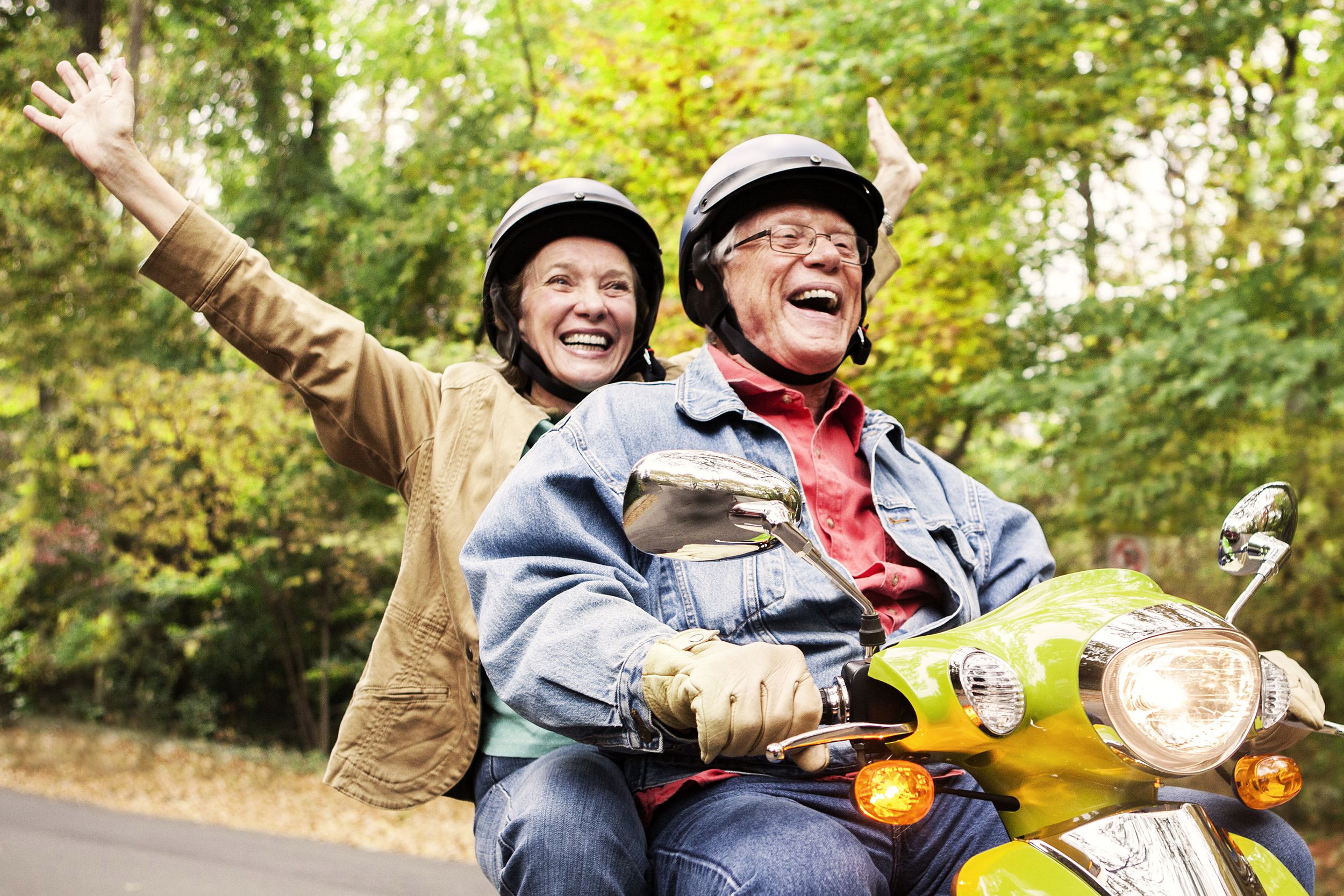 Senior couple having fun on a scooter