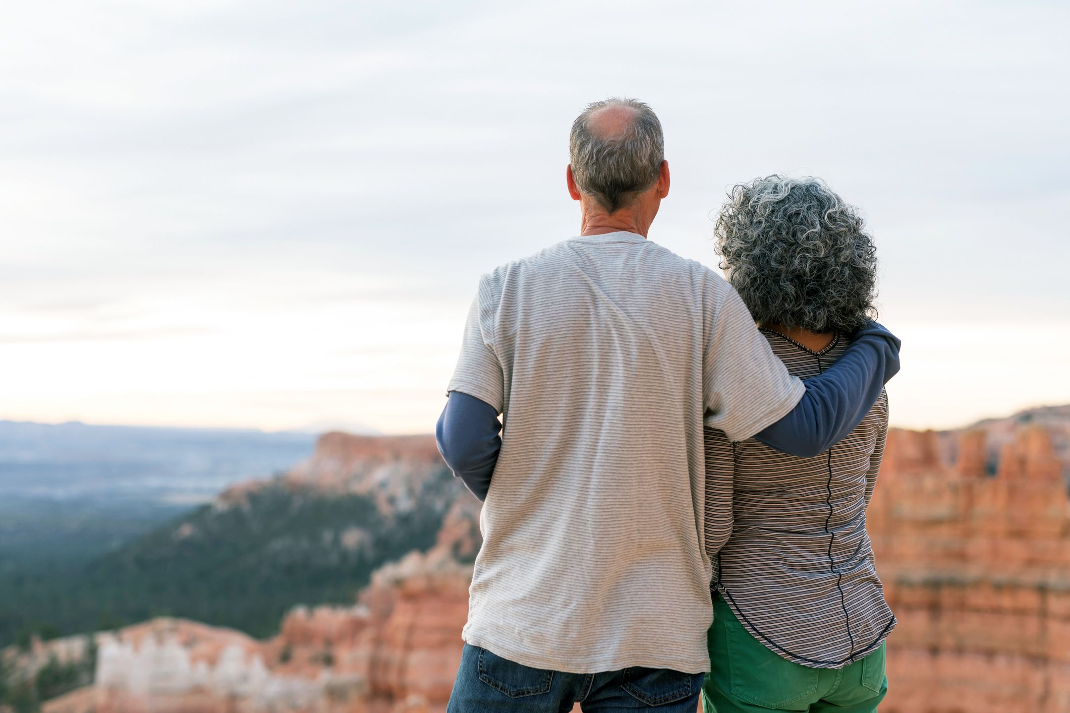 Senior couple looking over Bryce Canyon, Utah and sky, view of their backs
