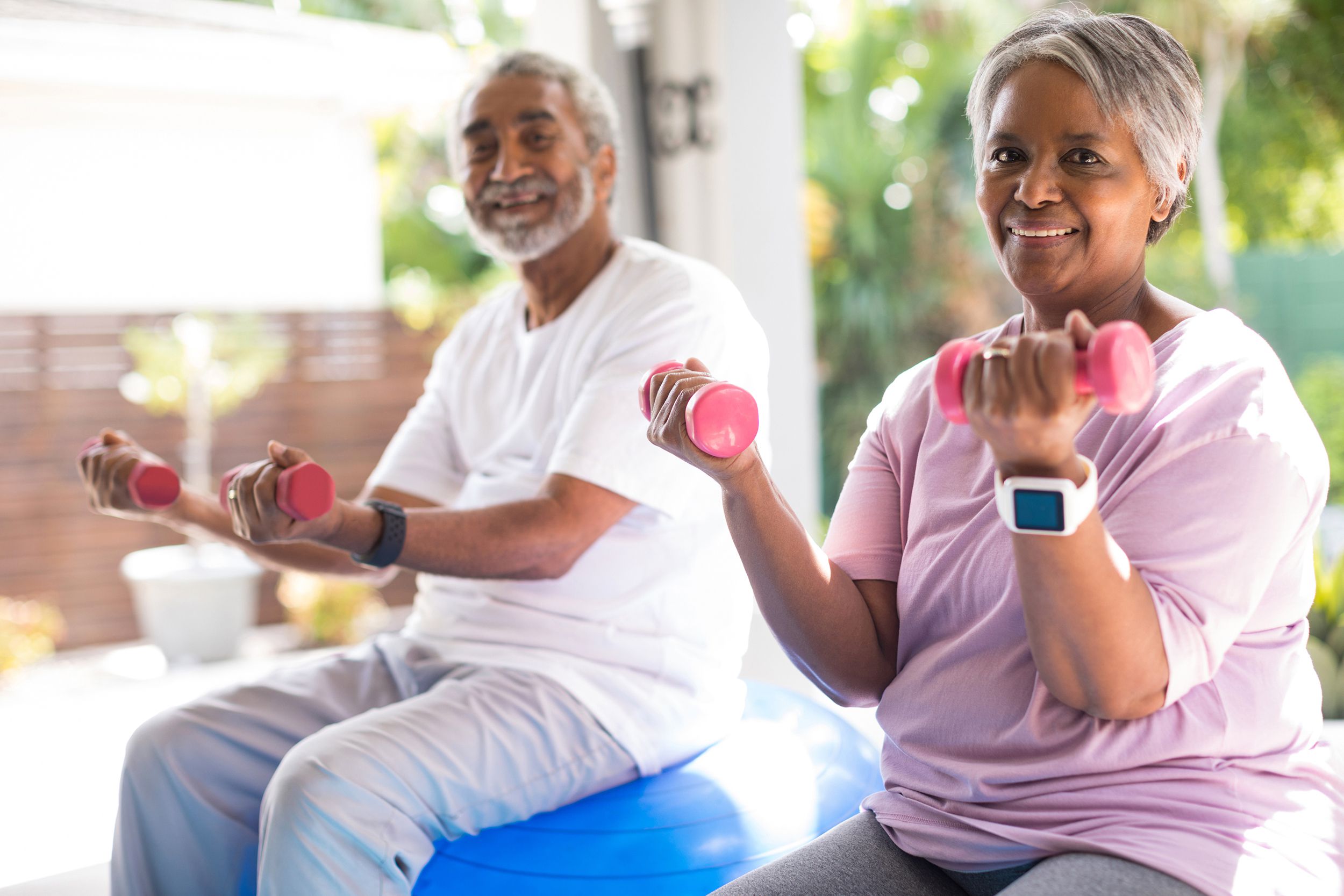 Senior couple holding dumbbells