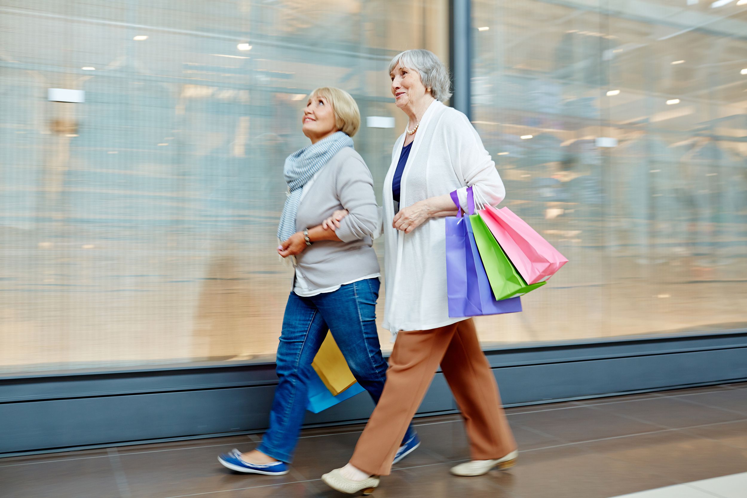 Senior female friends walking in the mall