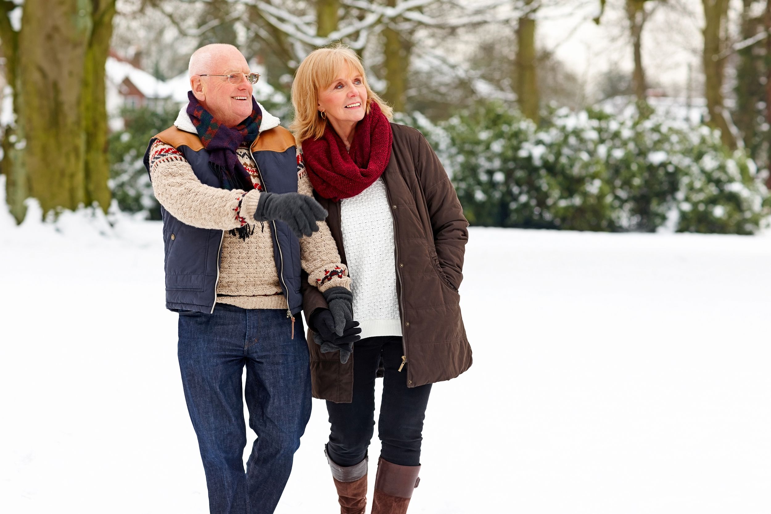 Senior couple walking outside in the snow