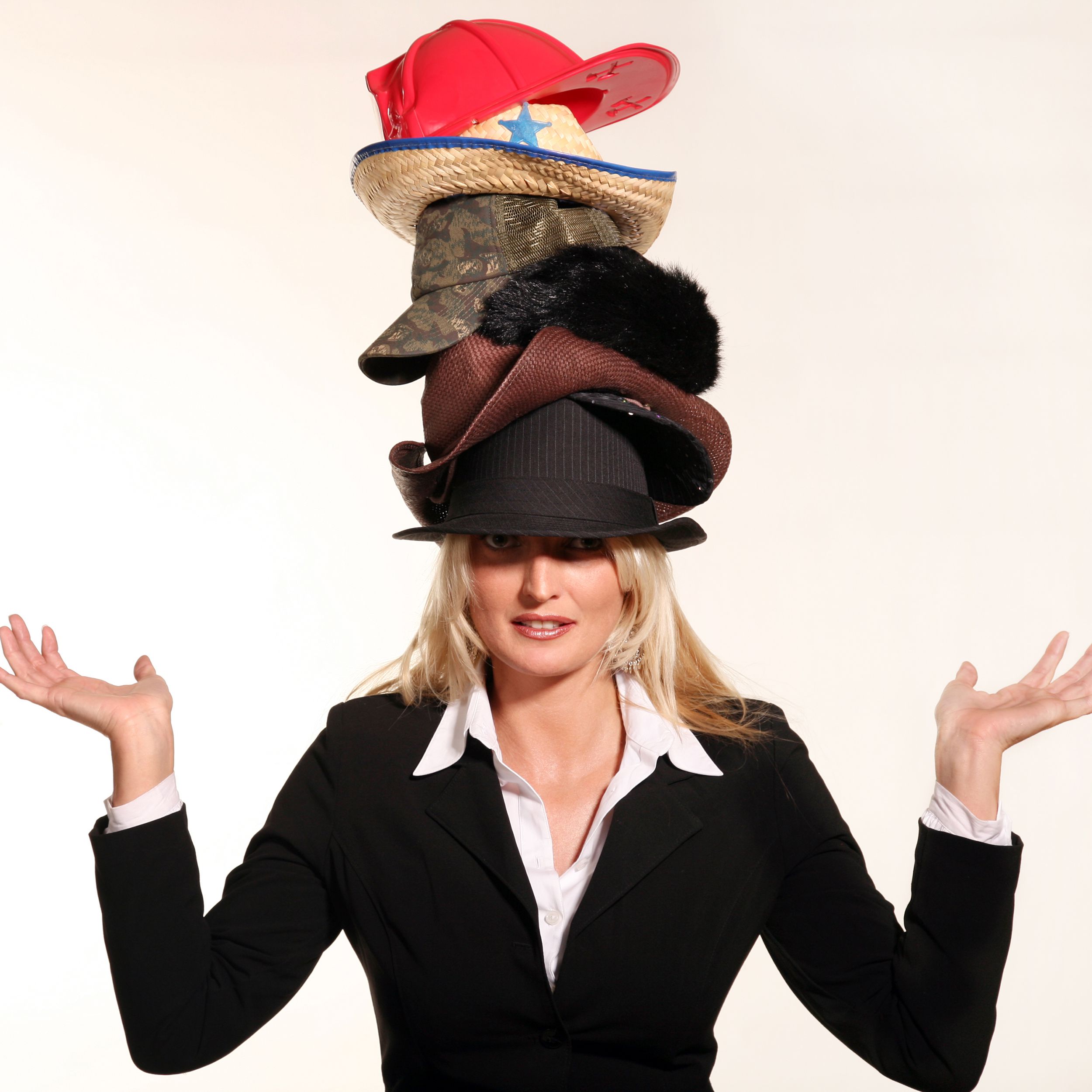 business woman balancing life having to wear too many hats