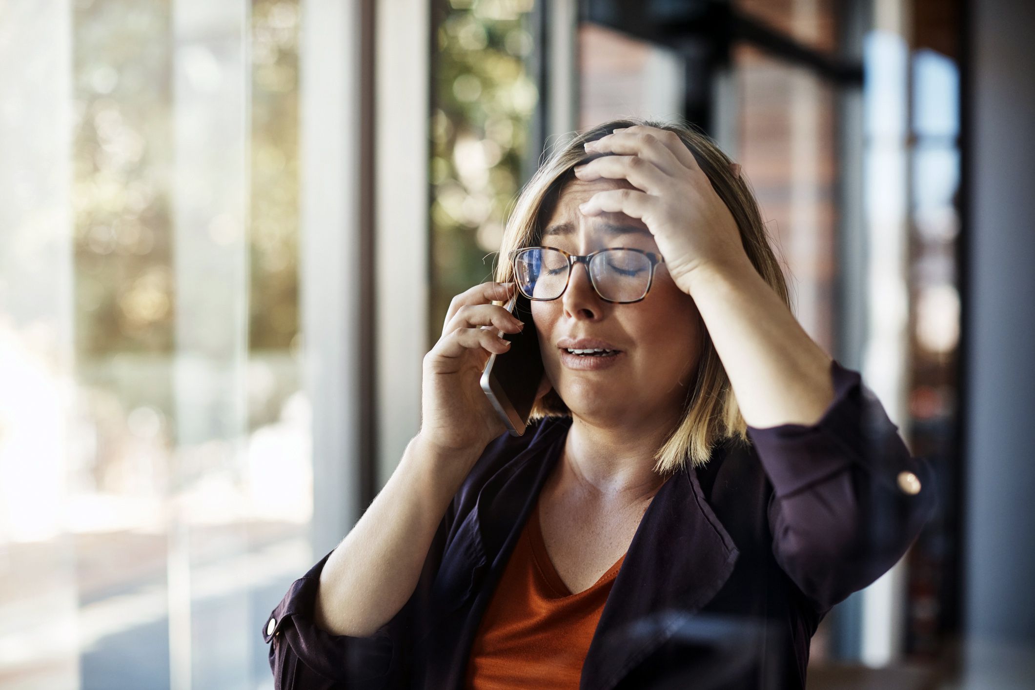 woman on verge of tears on phone