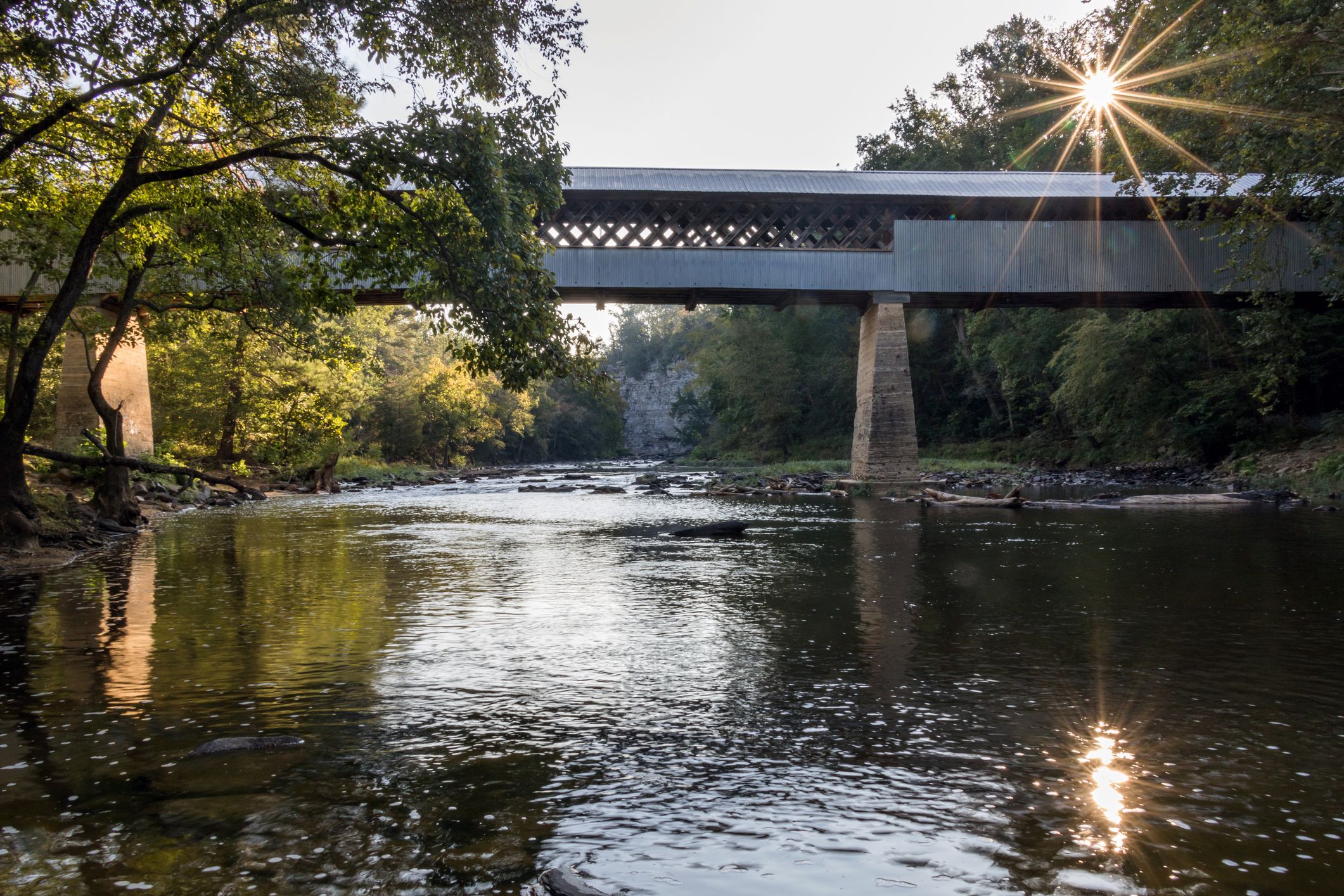 covered bridge over river in alabama