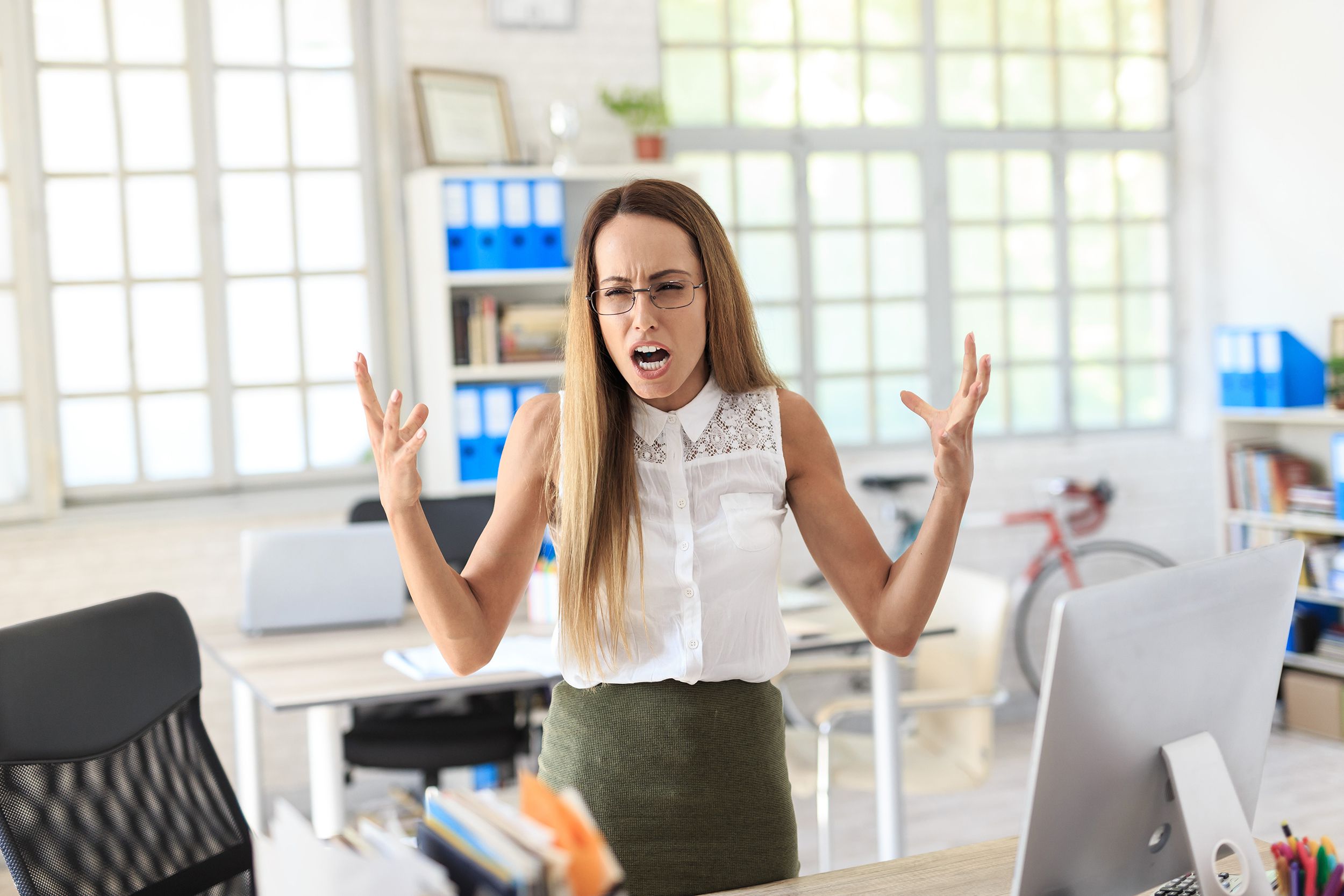 furious businesswoman shouting at work