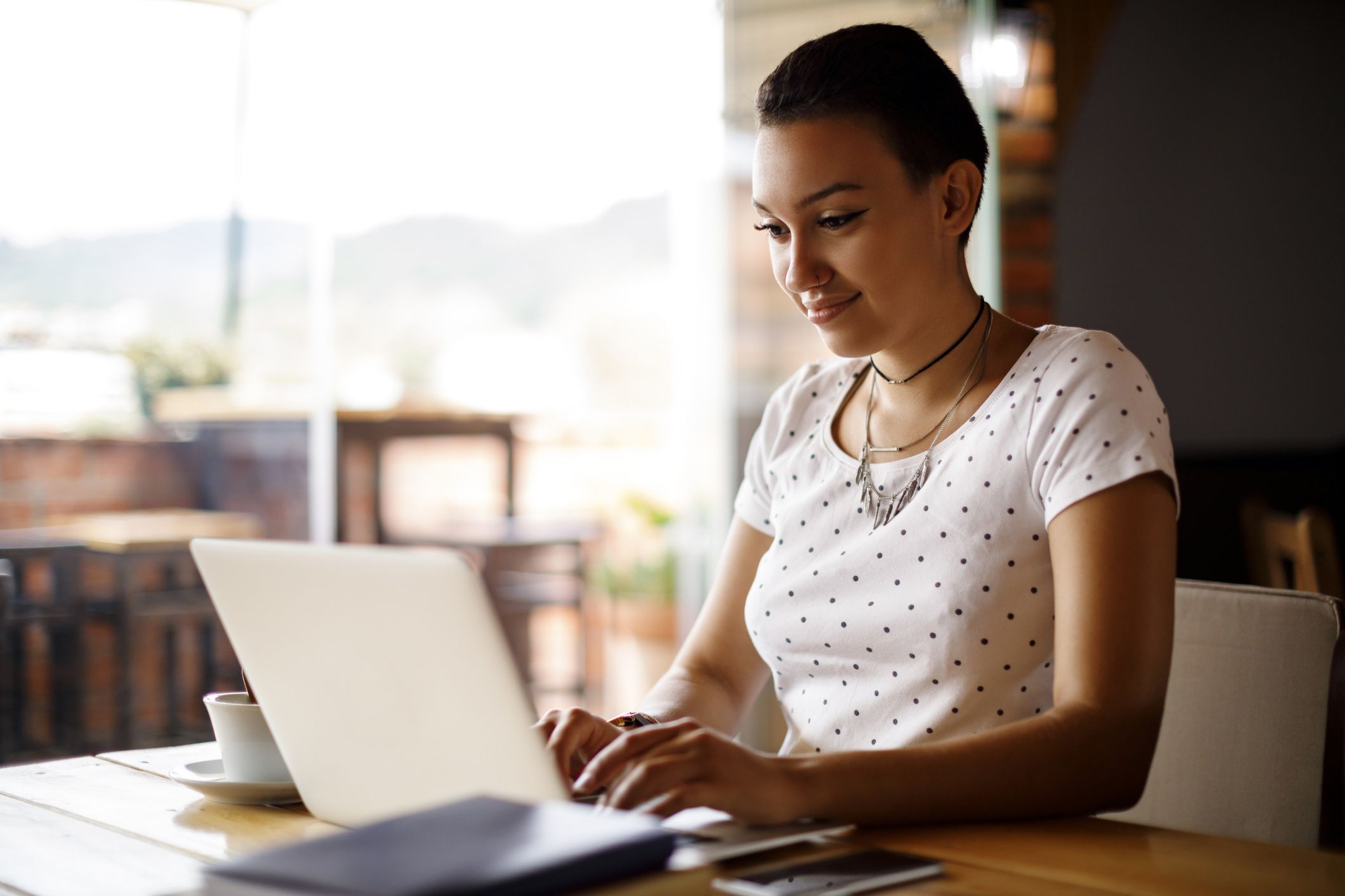 young woman at laptop in cafe