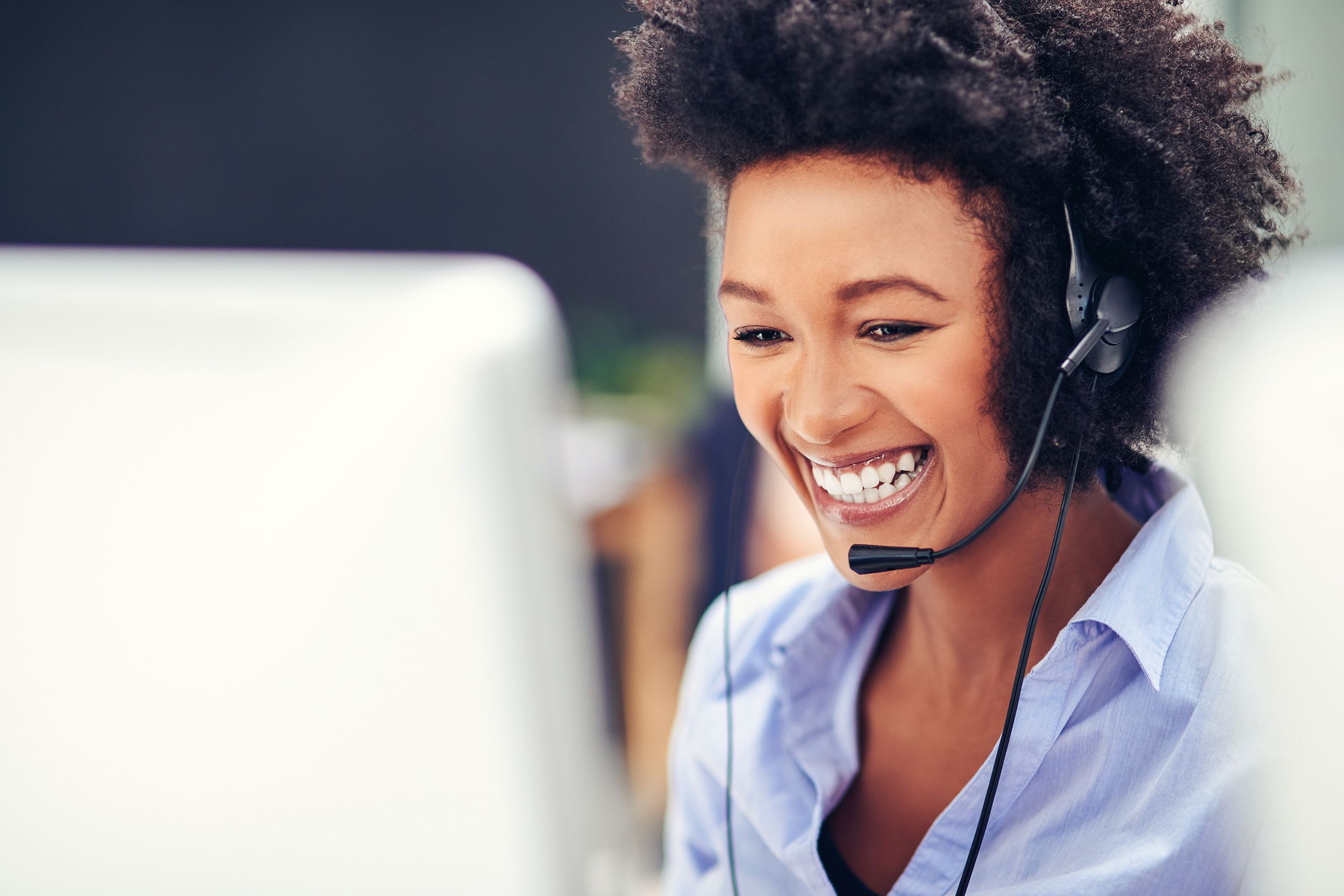 happy customer service agent working on the phone