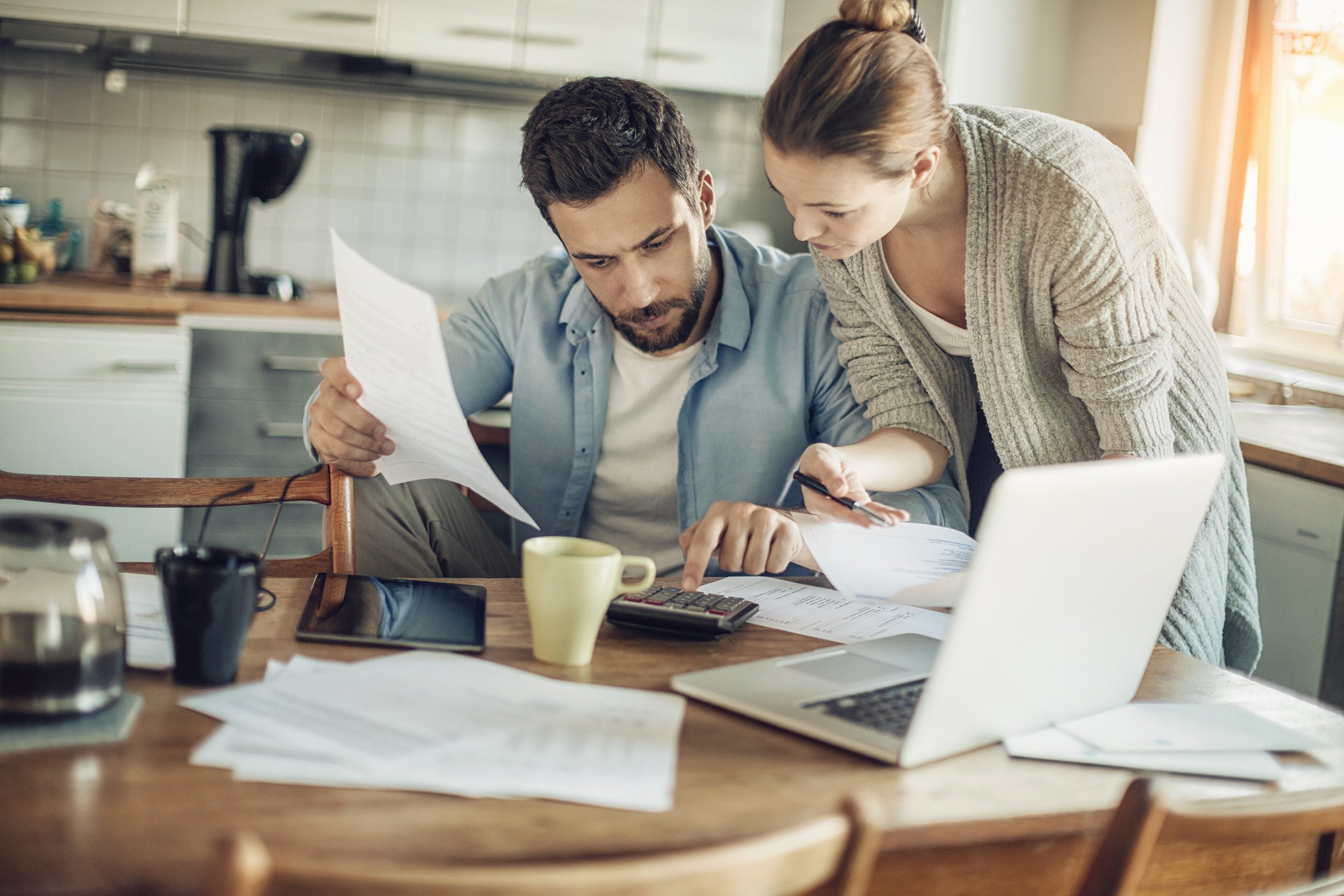 couple doing finances at kitchen table