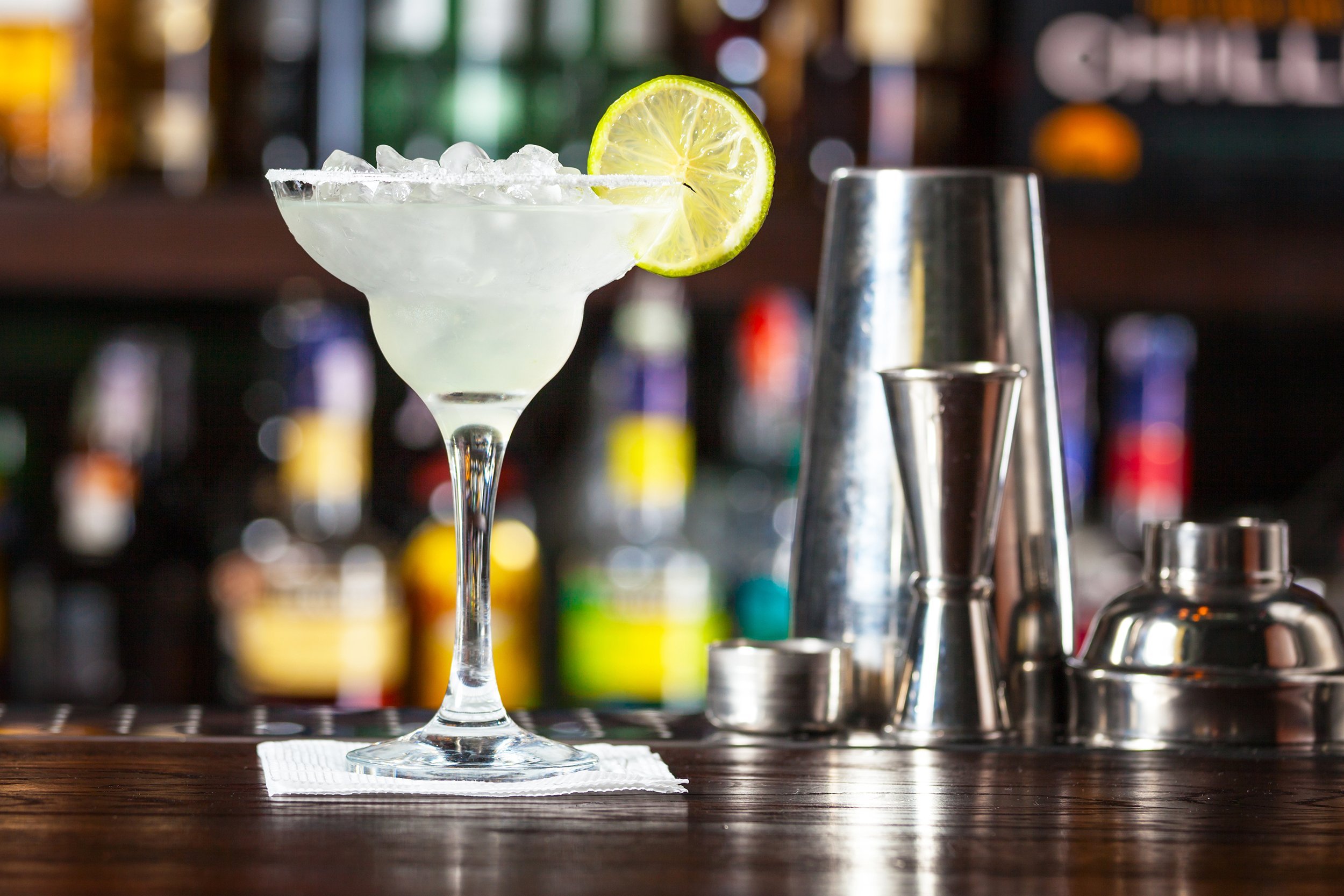 margarita garnished with lime standing on the bar counter