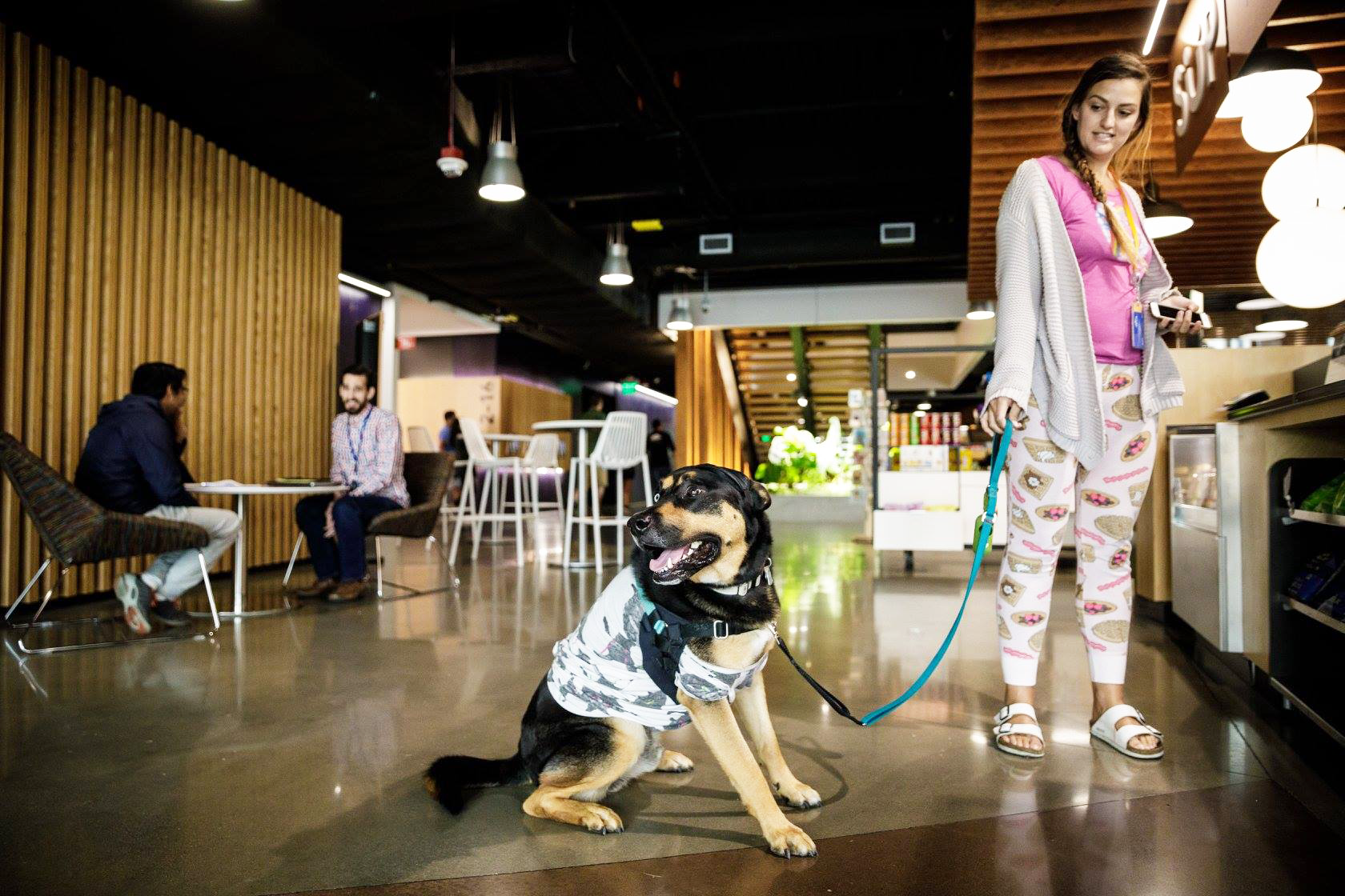 Woman wearing her pajamas with her dog at the Amazon office
