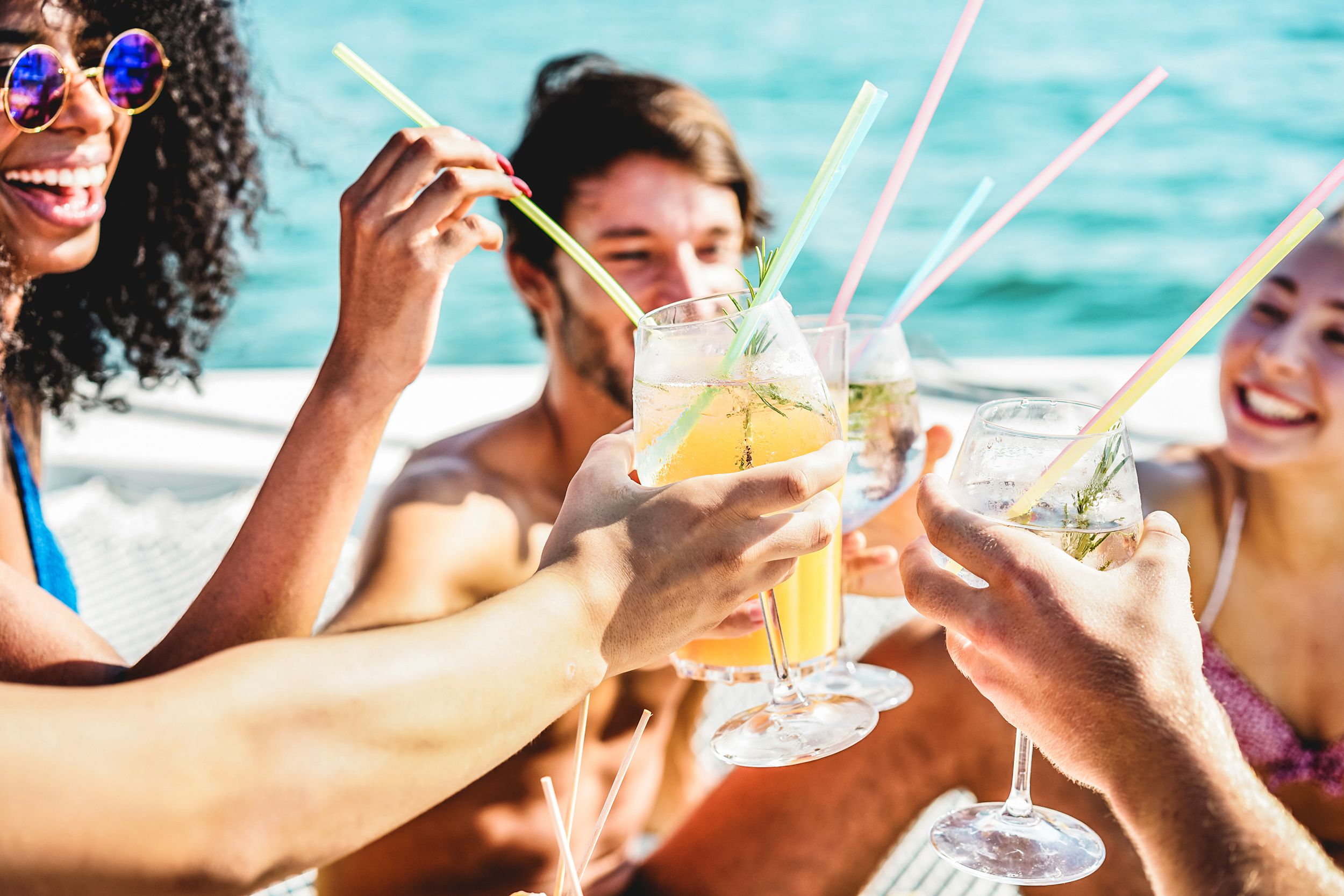 Friends toasting alcohol on a boat