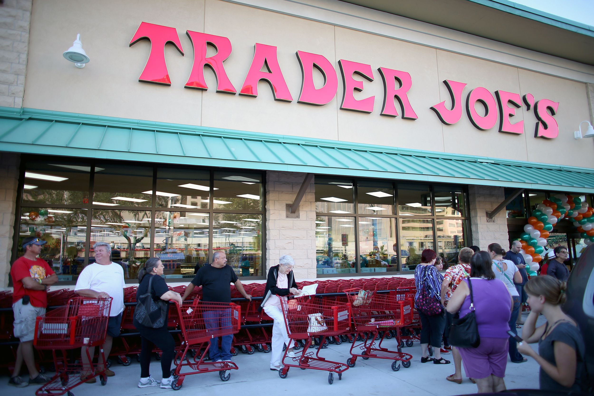 People standing in line outside of Trader Joe's in Miami