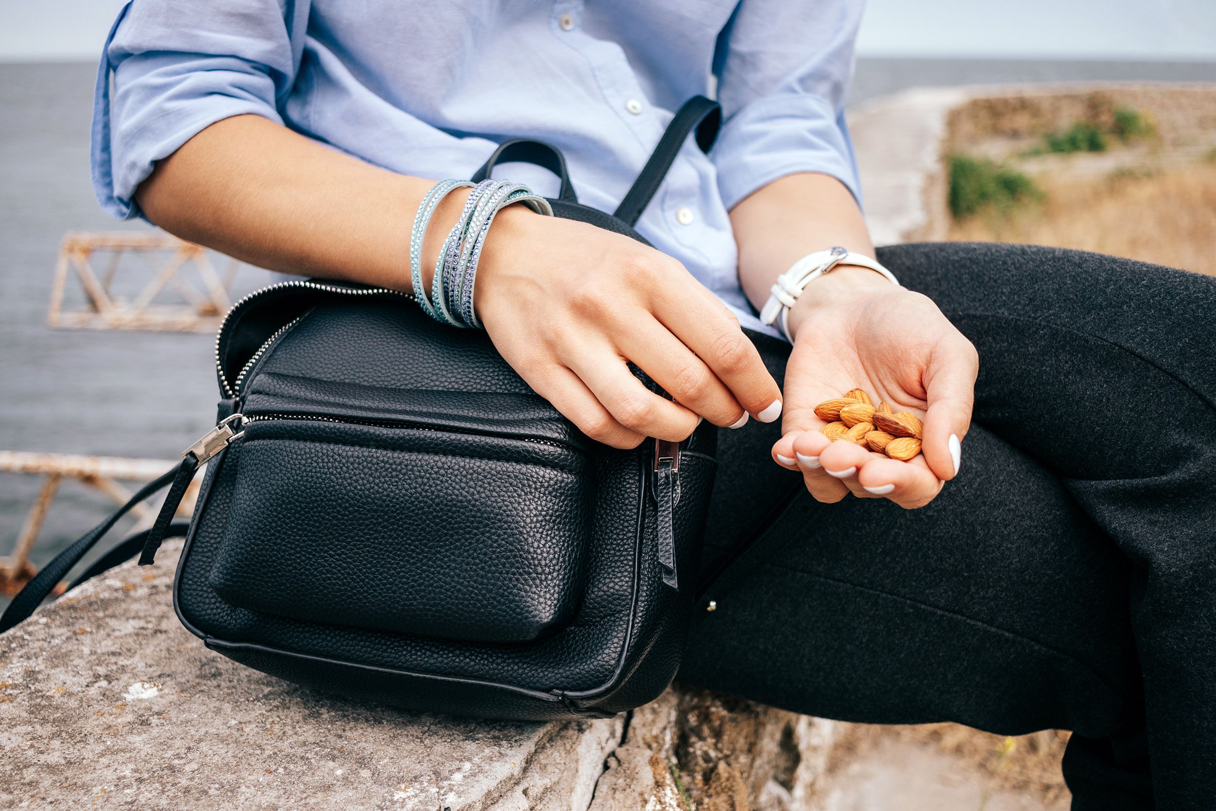 Woman eating a healthy snack of almonds